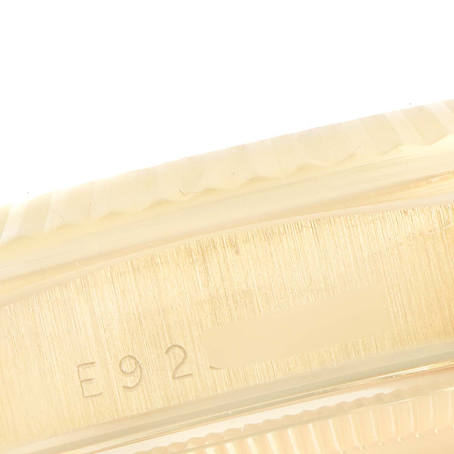 This close-up image of the Rolex President 18238 Men
s Yellow Gold Champagne Dial 18238 Men
s Yellow Gold Champagne Dial watch shows a section of the case with part of its serial number.