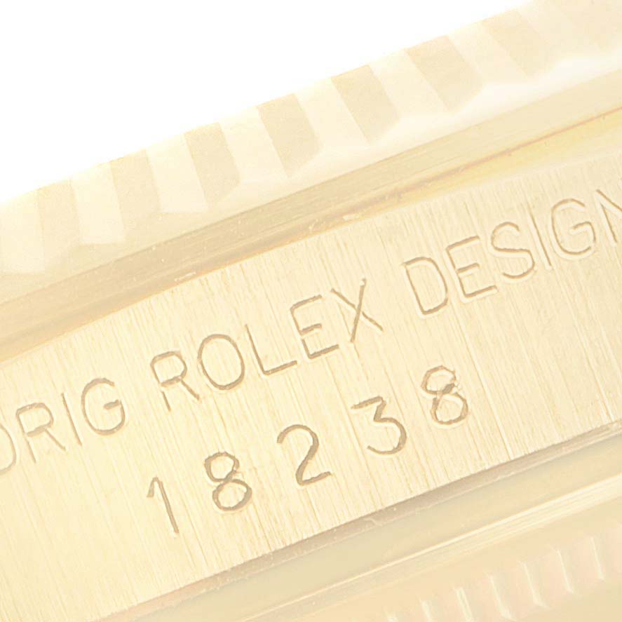 This close-up shows the model number and part of the fluted bezel of the Rolex President 18238 Men
s Yellow Gold Champagne Dial 18238 Men
s Yellow Gold Champagne Dial watch.