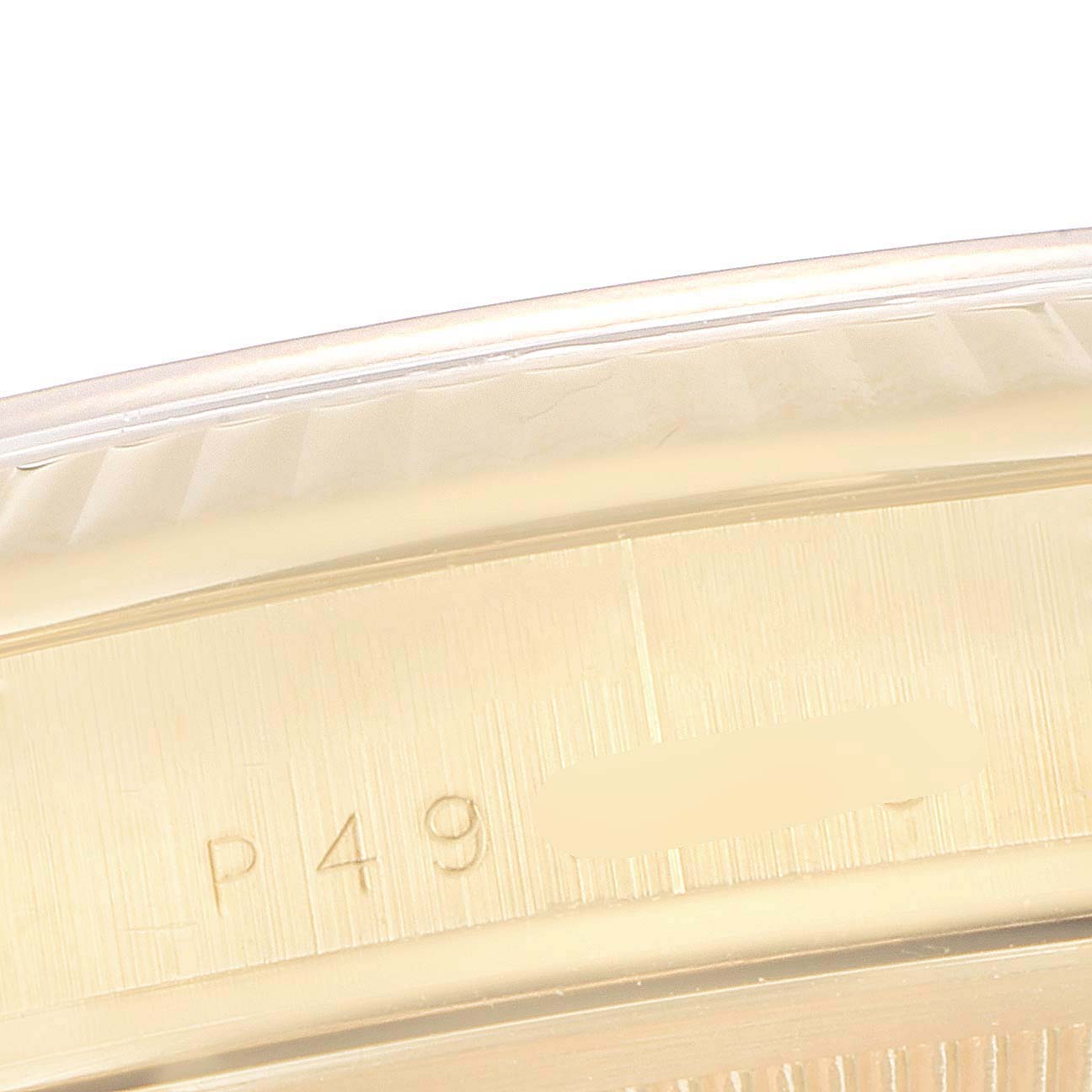 This close-up image shows a partial view of the bezel and case back with engravings on a Rolex President 118238 Men's Yellow Gold Mother of Pearl Dial 118238 Men's Yellow Gold Mother of Pearl Dial model watch.