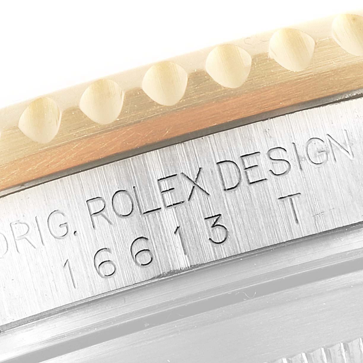 This image shows a close-up of the side engraving on the bezel and case of a Rolex Submariner 16613 Men's Steel and Gold (two tone) Black Dial 16613 Men's Steel and Gold (two tone) Black Dial watch.
