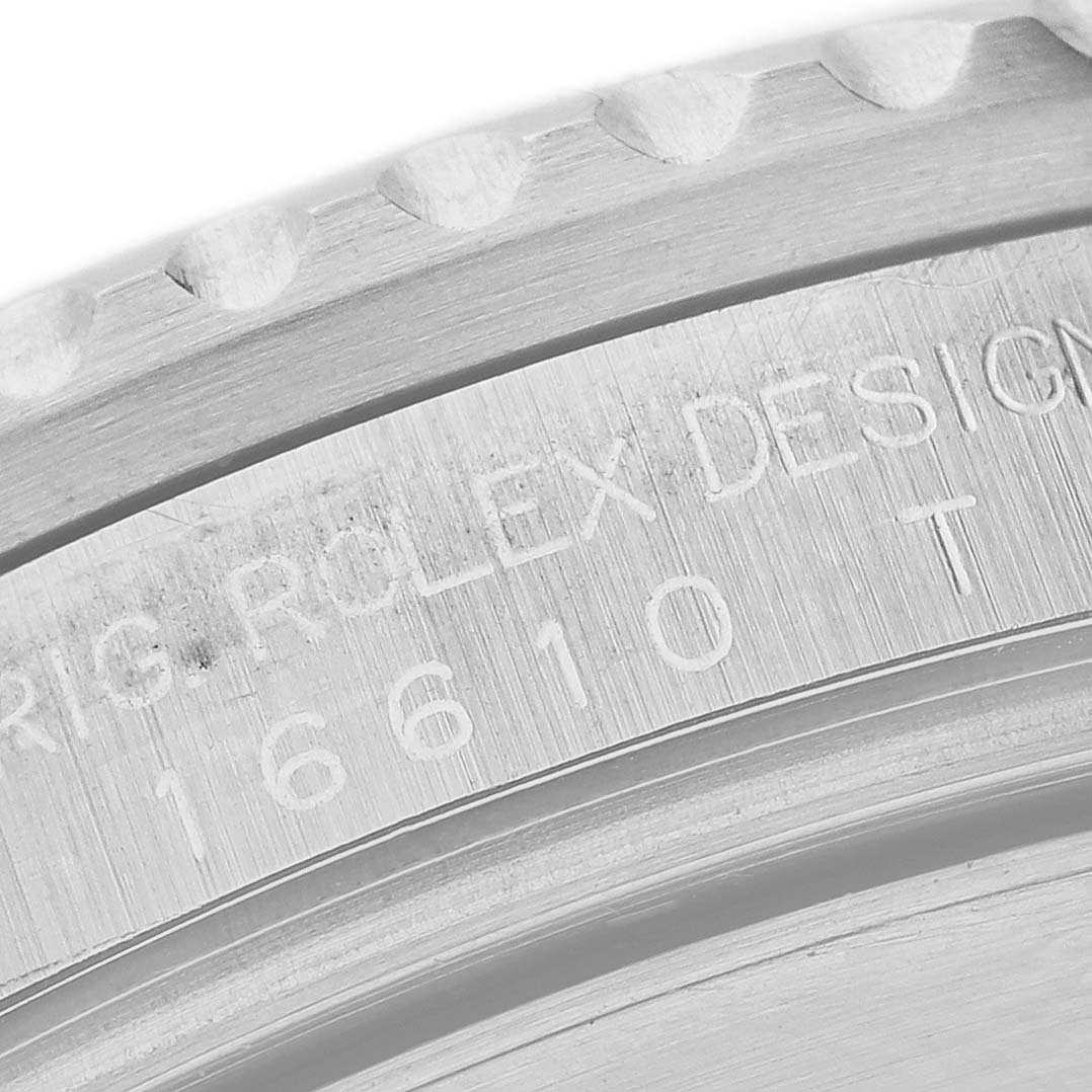 The close-up image shows the engraved edge and model number "16610" of a Rolex Submariner 16610 Men
s Stainless Steel Black Dial 16610 Men
s Stainless Steel Black Dial watch case.