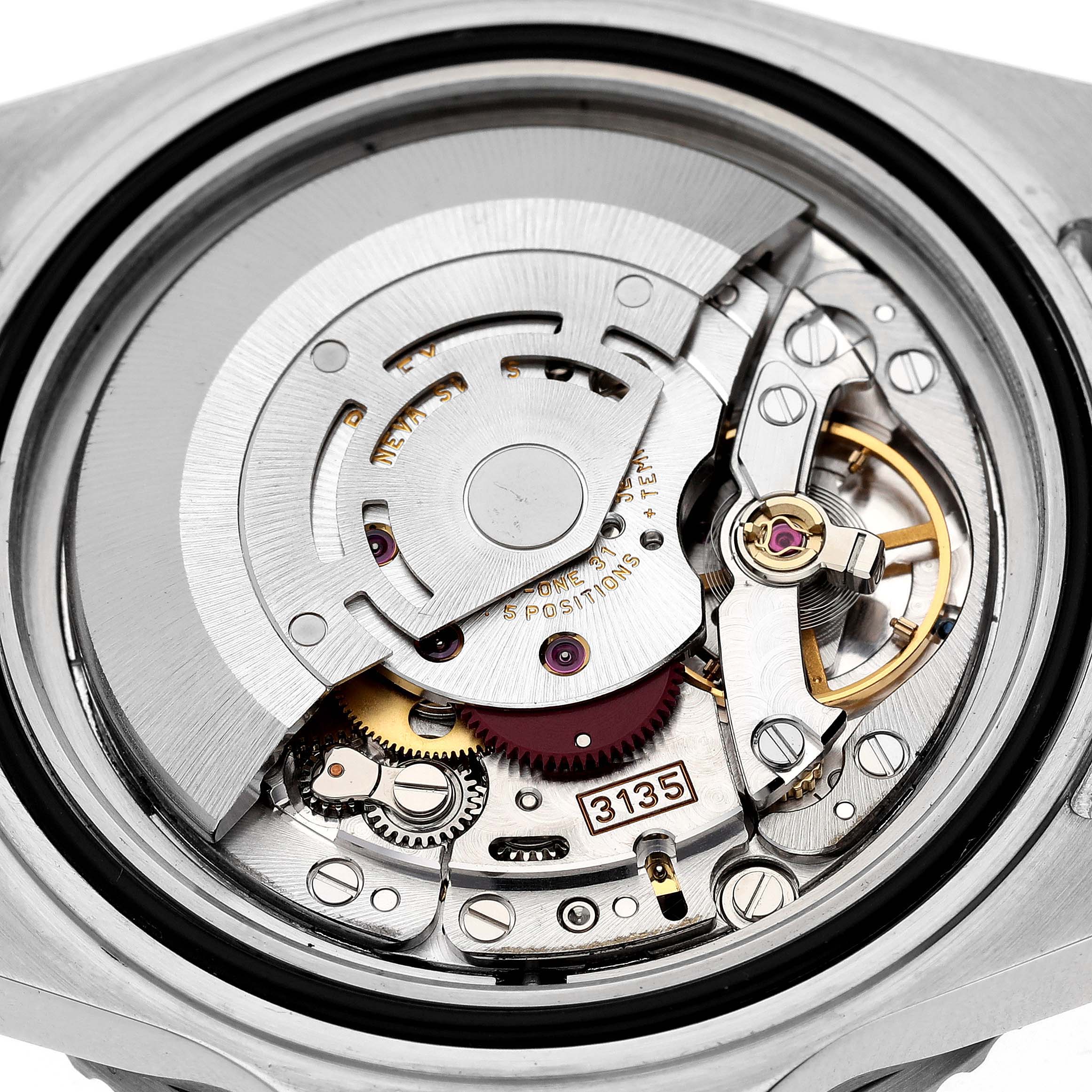 The image shows the interior mechanics, including the movement and rotor, of a Rolex Submariner 16610 Men
s Stainless Steel Black Dial 16610 Men
s Stainless Steel Black Dial watch from a rear angle.