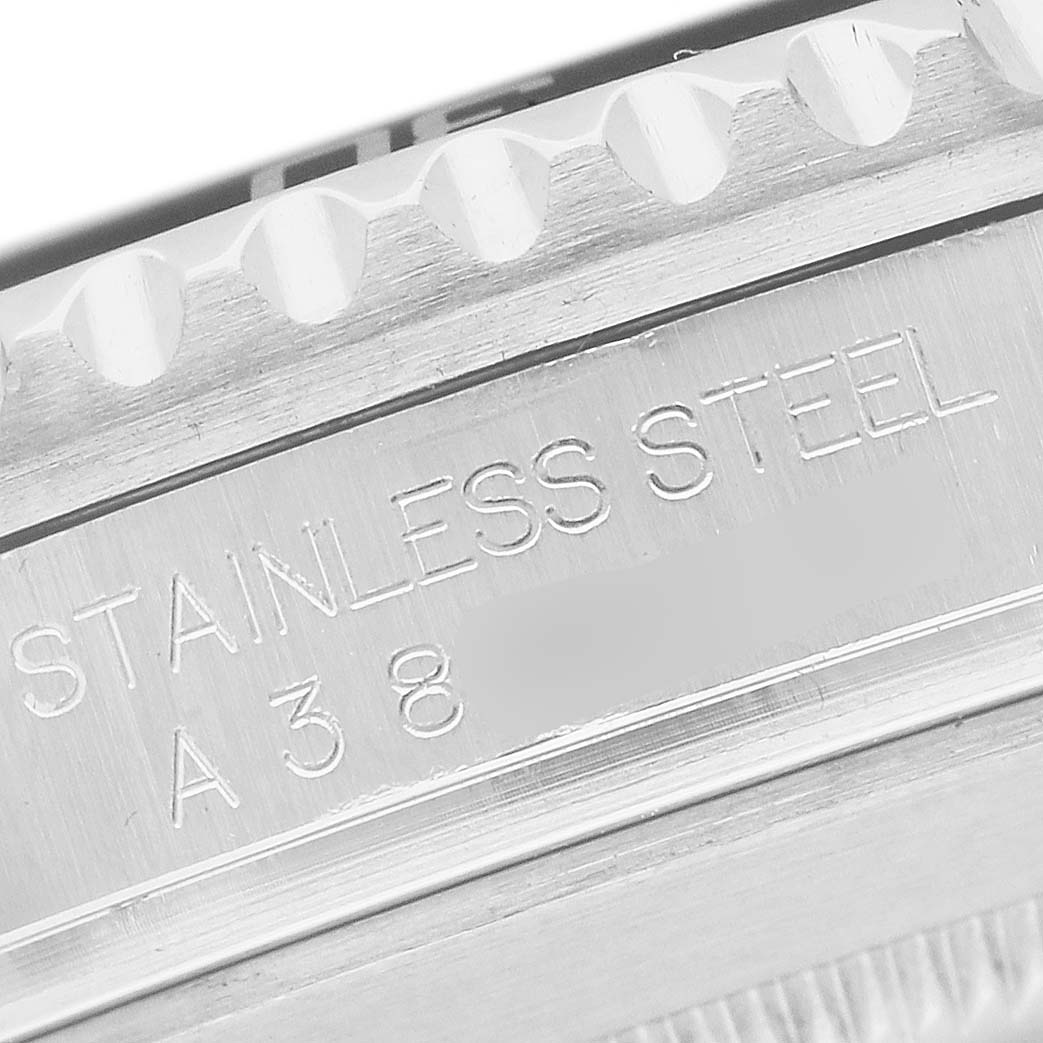 The image shows a close-up of the stainless steel case with visible engravings on the Rolex Submariner 16610 Men's Stainless Steel Black Dial.
