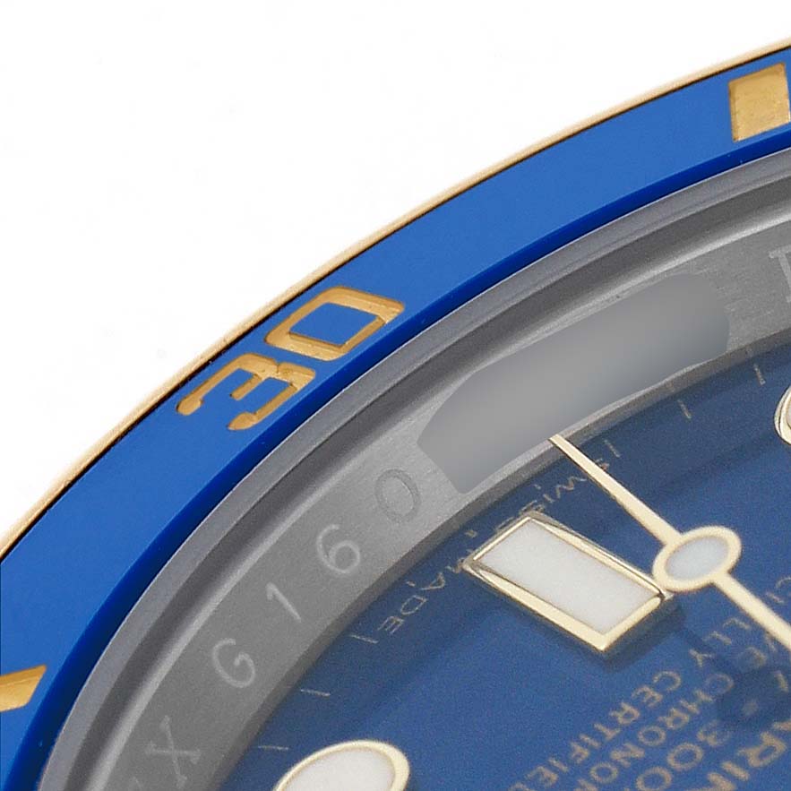 The image shows a close-up of the bezel, dial, and hands of the Rolex Submariner 116613LB Men's Steel and Gold (two tone) Blue Dial model, focusing on the 30-minute mark.