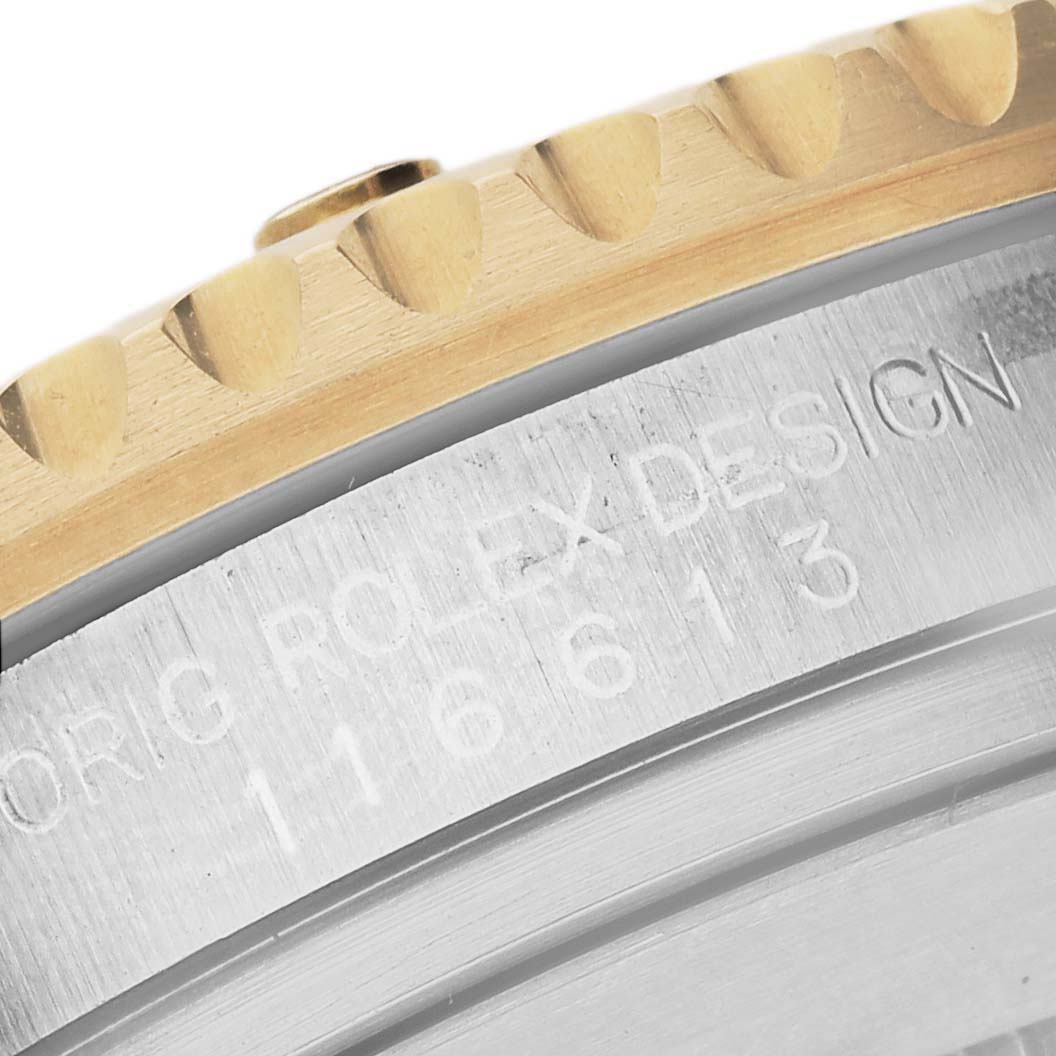 The image shows the side view of a Rolex Submariner 116613LB Men's Steel and Gold (two tone) Blue Dial, highlighting the bezel and engraved case details.