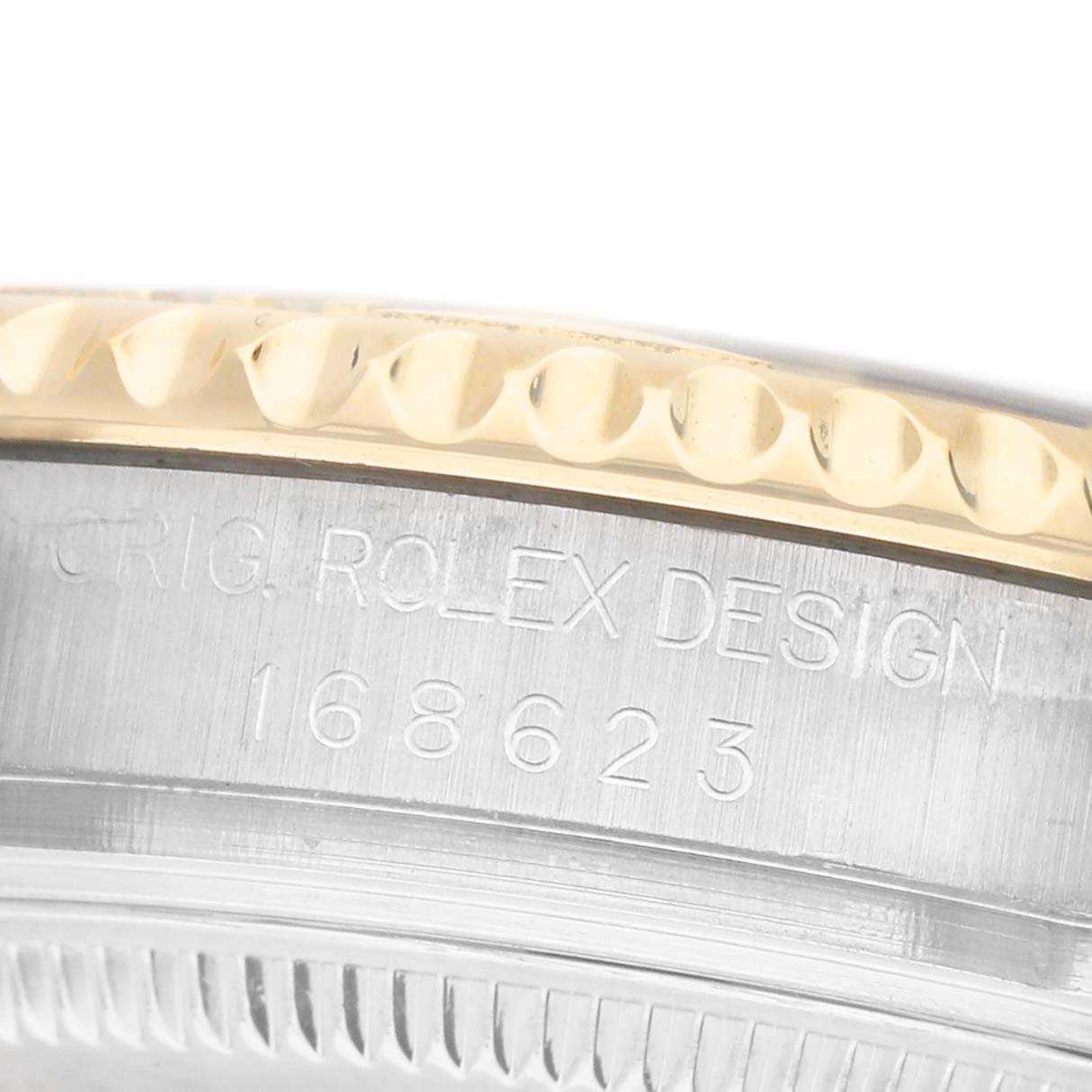 The image shows a close-up of the Rolex Yacht-Master 168623 Men's Steel and Gold (two tone) White Dial watch's case side, highlighting the engraved model number and edge details.
