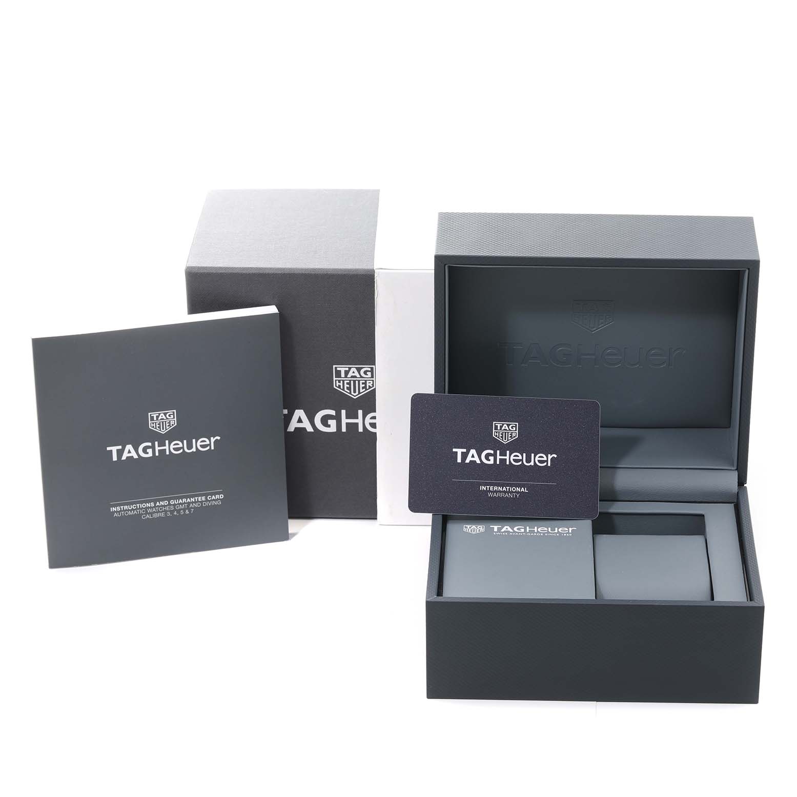 The image shows the packaging, international warranty card, and instruction manual for the Tag Heuer Carrera CBN2011.BA0642 Men's Stainless Steel Blue Dial CBN2011.BA0642 Men's Stainless Steel Blue Dial watch model.