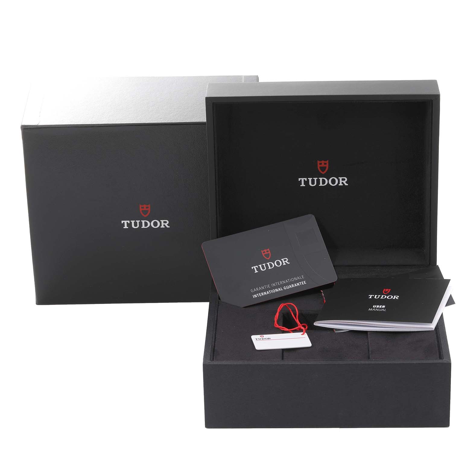 The image shows the open packaging of the Tudor Heritage Black Bay 7941A1A0RU Men
s Stainless Steel Black Dial 7941A1A0RU Men
s Stainless Steel Black Dial, including the box, manuals, and warranty card.