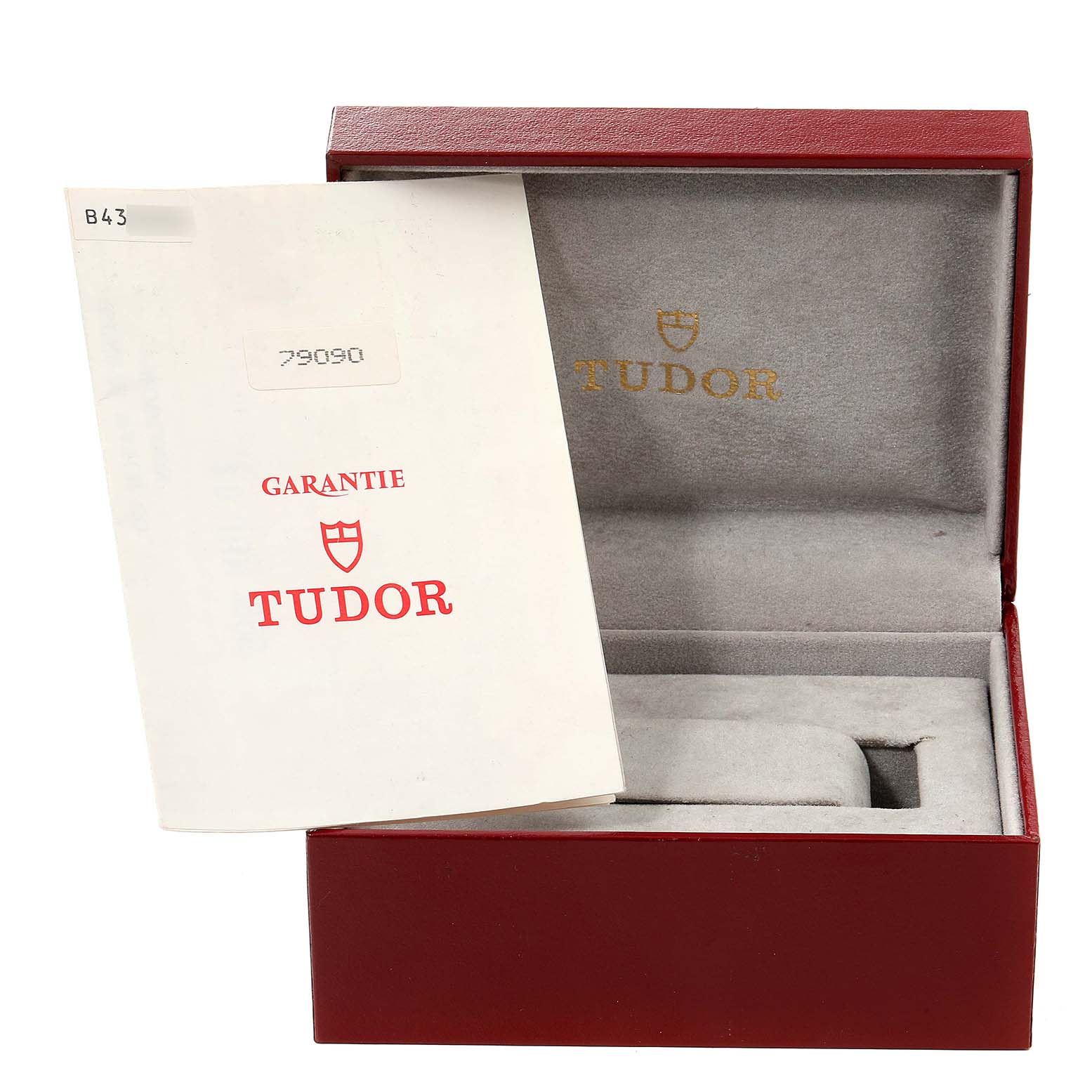 This image shows the open box and warranty card for a Tudor Submariner 79090 Men's Stainless Steel Black Dial 79090 Men's Stainless Steel Black Dial watch.