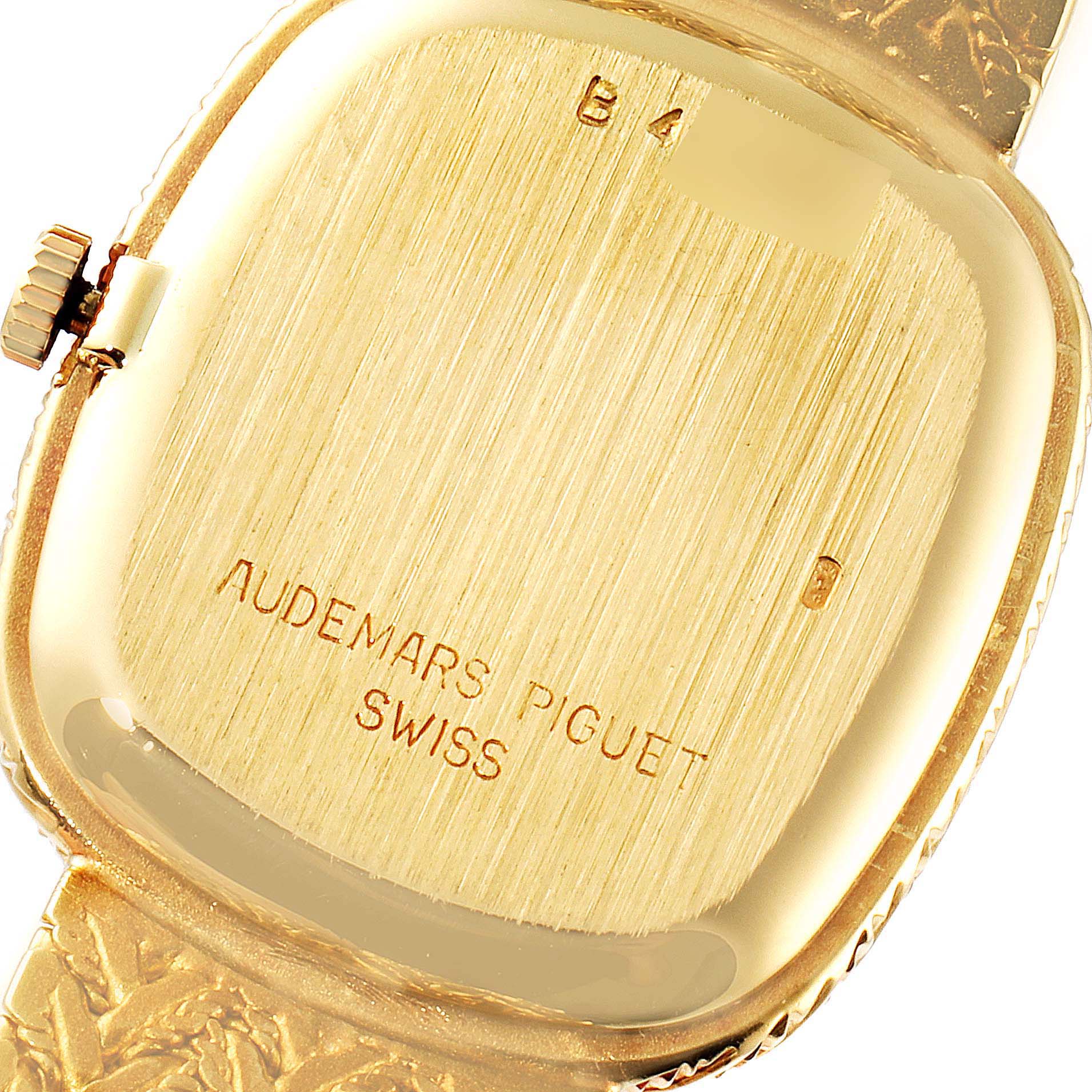 The image shows the back case and part of the crown of a Vintage Audemars Piguet watch at an angle.