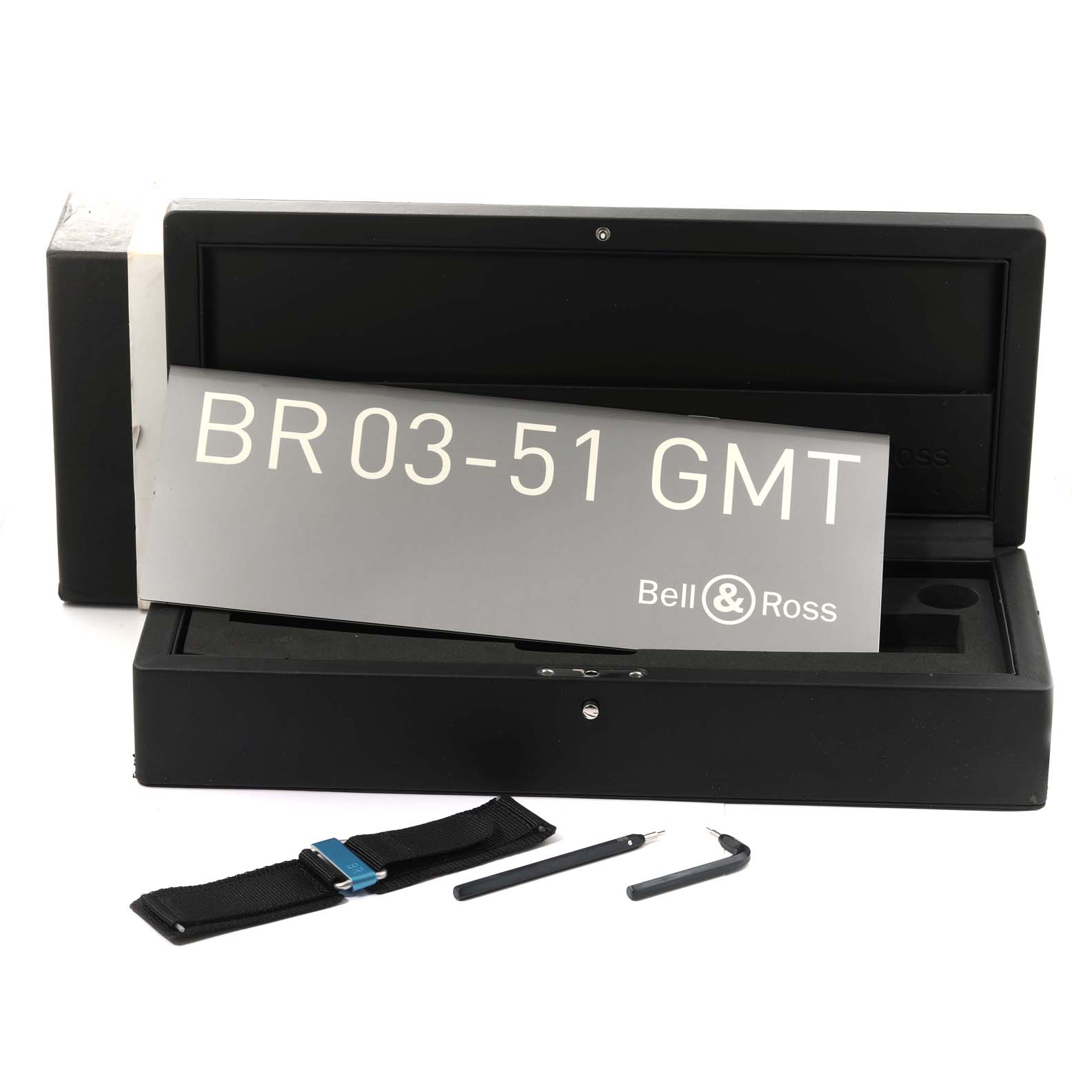 The image shows the open box of a Bell & Ross Aeronavale BR03-51 GMT watch with a strap and tools placed in front.