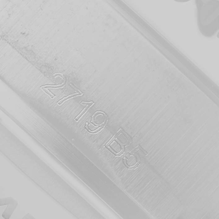 The image shows a close-up of the engraved serial number on the strap or clasp of a Breitling Aviator AB01192A1L1A1 Men's Stainless Steel Green Dial watch.