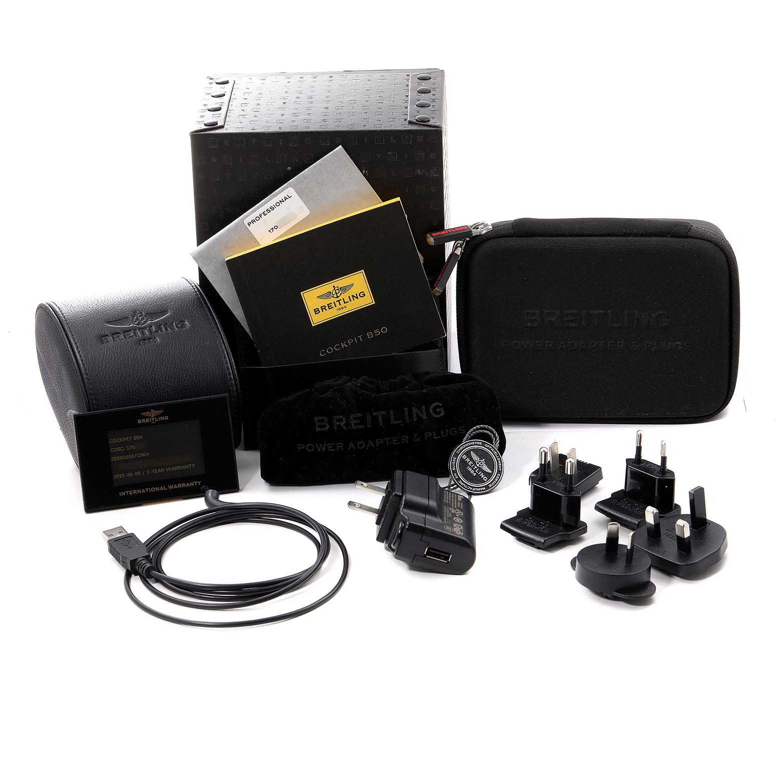 The image shows accessories for a Breitling Professional Series EB5010 Men's Titanium Blue Dial EB5010 Men's Titanium Blue Dial watch, including a box, manuals, cases, adapters, and a cable.