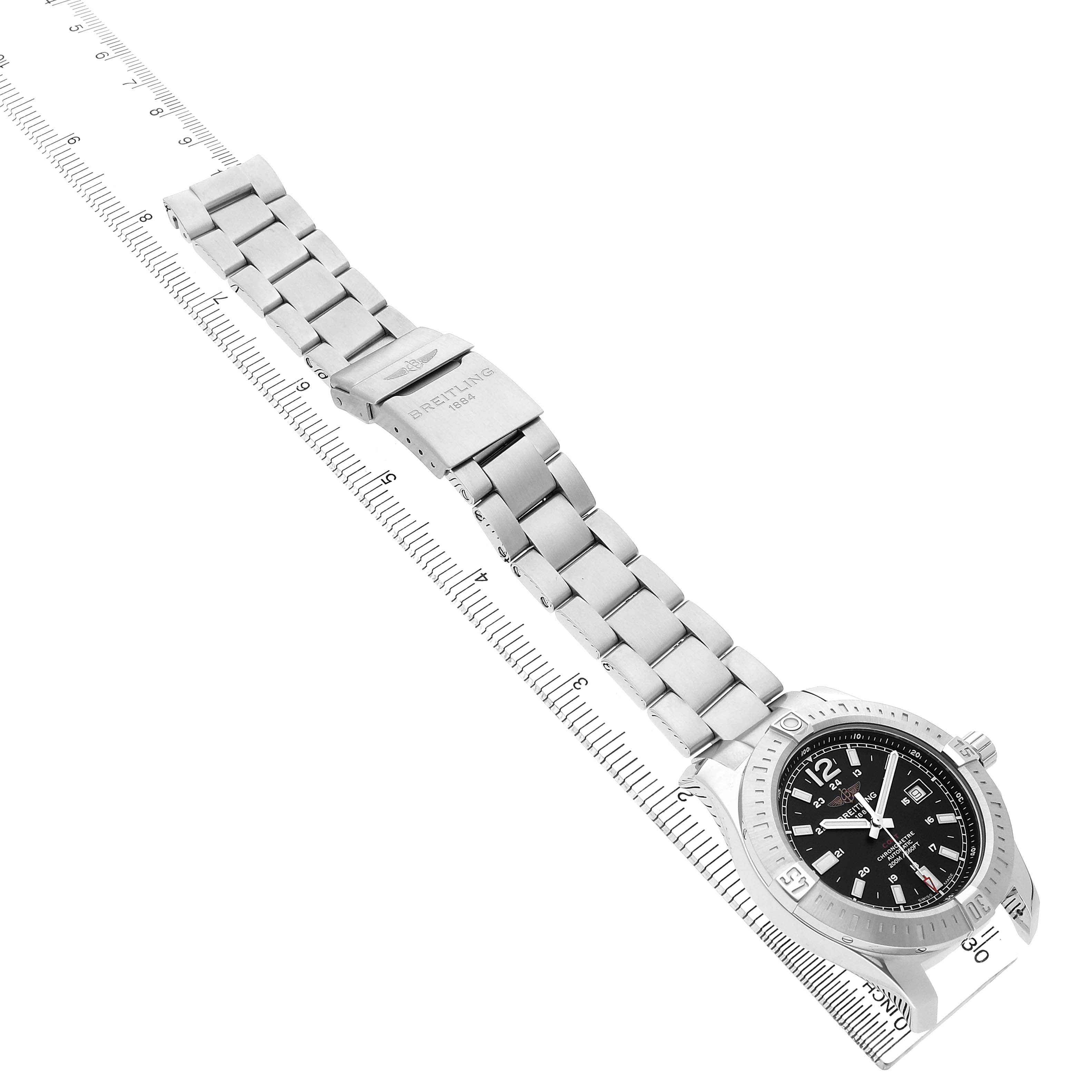 The image shows a Breitling Colt A1738811/BD44 Men's Stainless Steel Black Dial watch from a top angle, displaying its stainless steel band, clasp, and black dial.