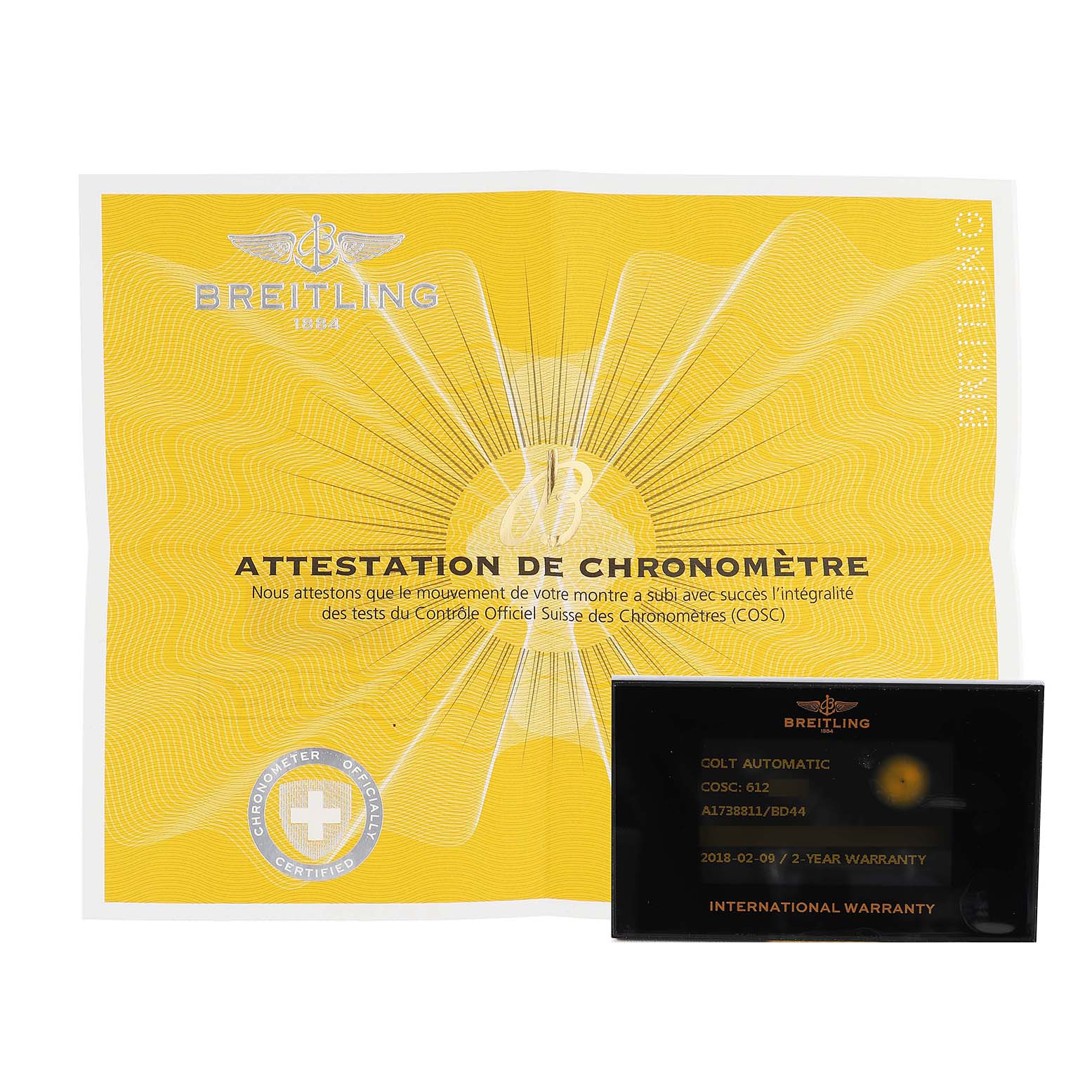 The image shows a Breitling Colt A1738811/BD44 Men's Stainless Steel Black Dial warranty card and chronometer certificate, viewed from the front.