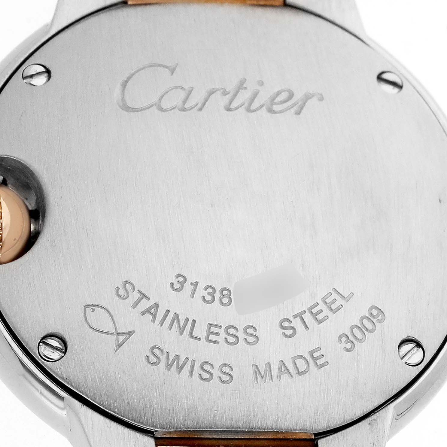 The image shows the back of the Ballon Bleu by Cartier, featuring engravings and a partial view of the strap attachment.