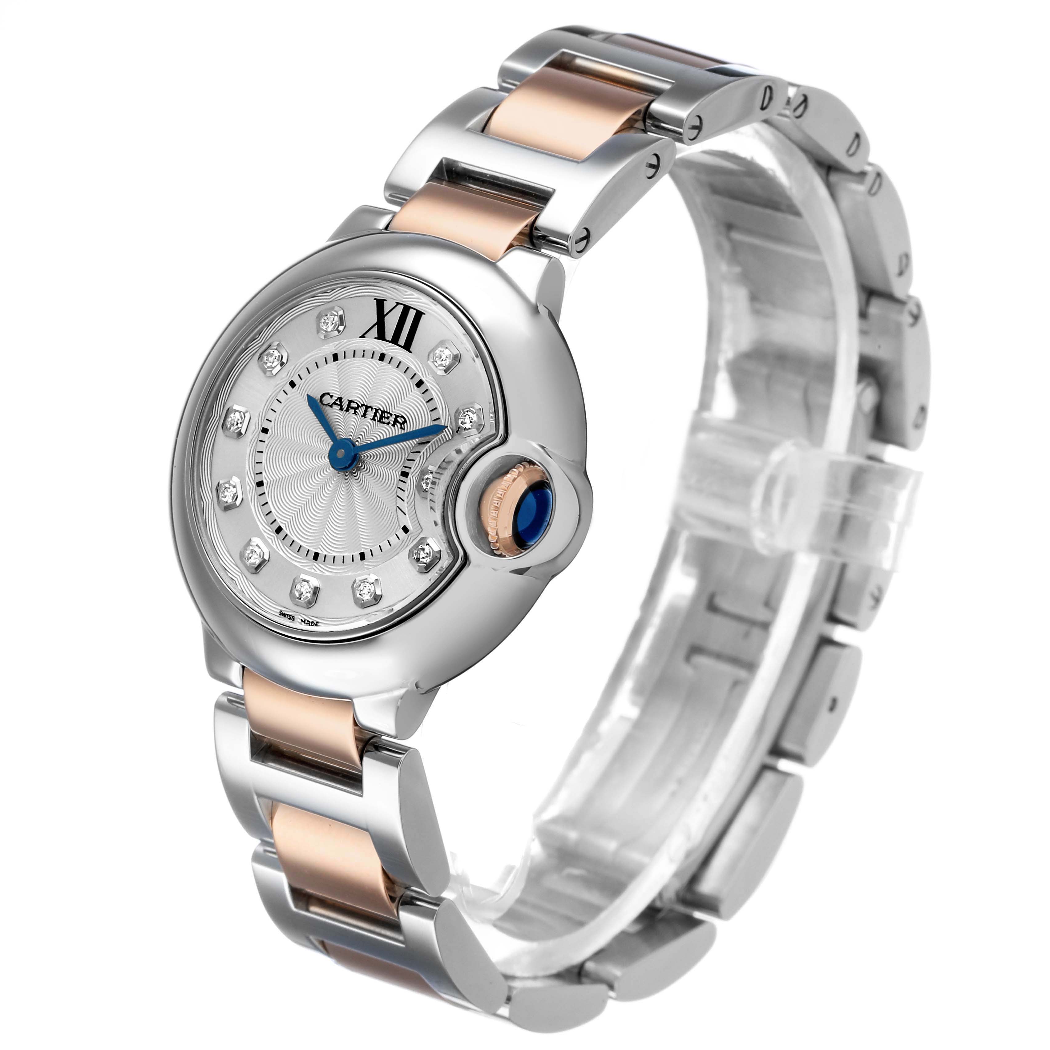 The Cartier Ballon Bleu WE902030 Women's Steel and Gold (two tone) Silver Dial watch is shown at an angled side view, highlighting the face, crown, and two-tone bracelet.