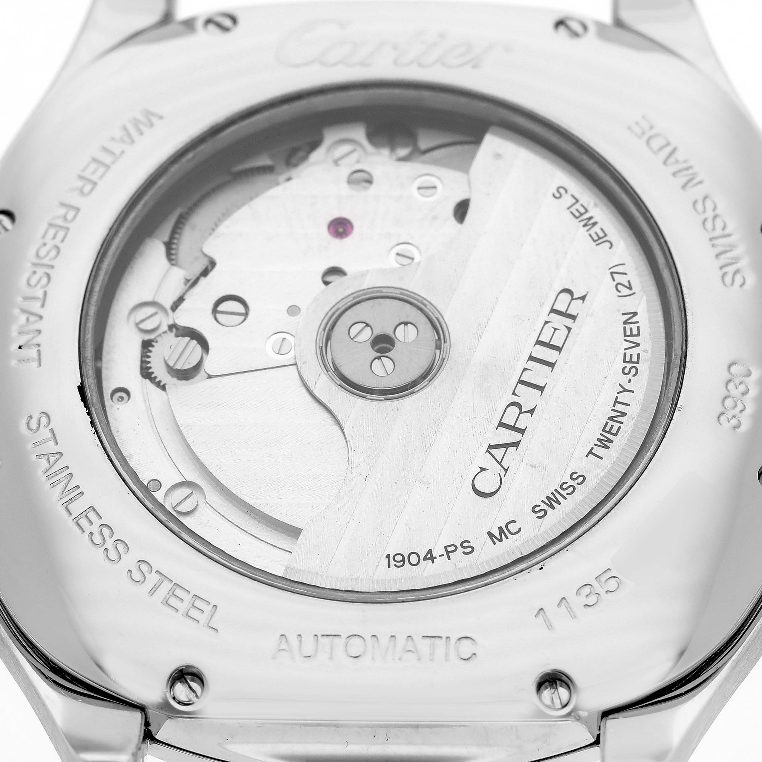 The image shows the back view of a Drive de Cartier watch by Cartier, highlighting its movement and engravings.