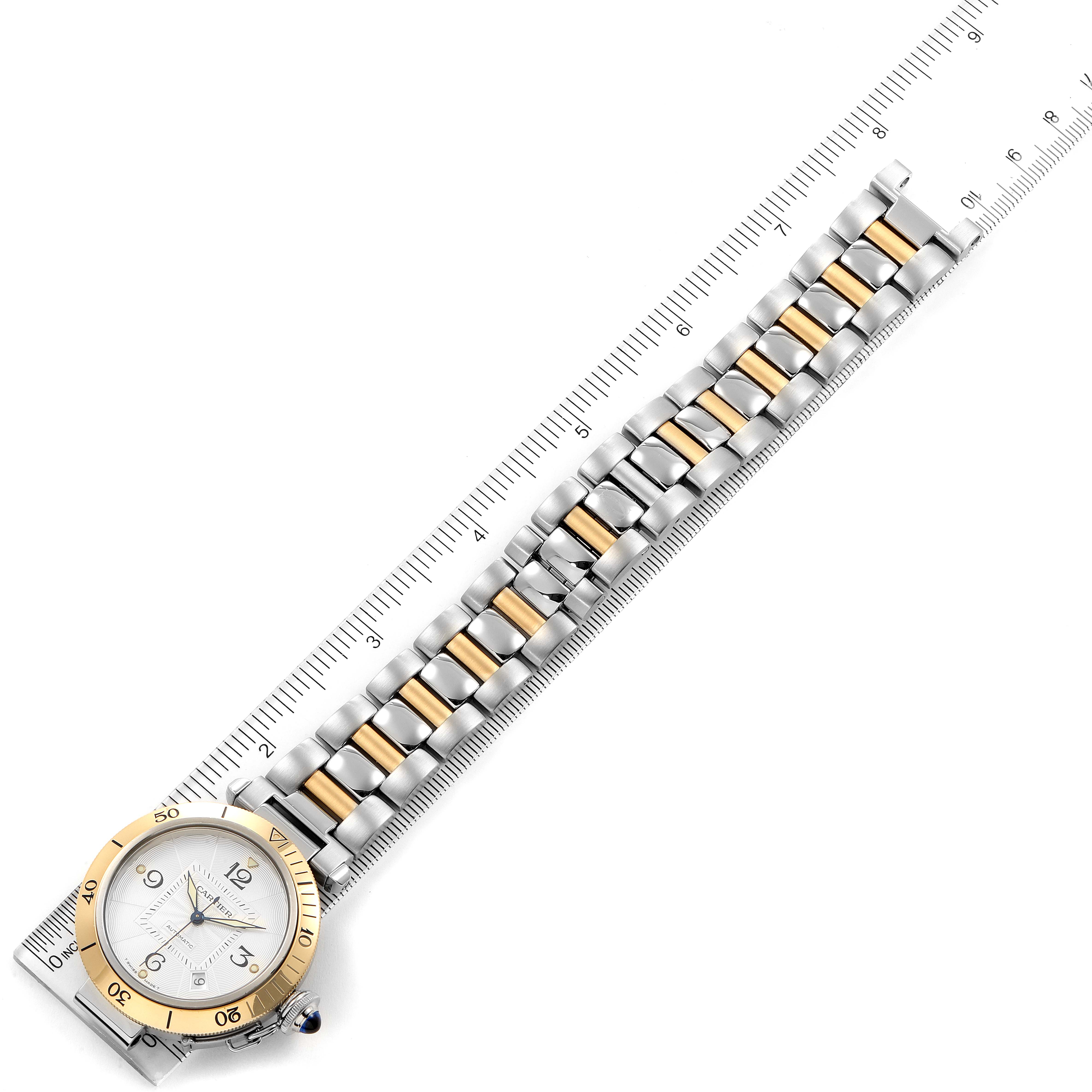 This image shows a Cartier Pasha 2378 Men's Steel and Gold (two tone) Silver Dial 2378 Men's Steel and Gold (two tone) Silver Dial watch laid flat next to a ruler for measurement, showing the full face and band.
