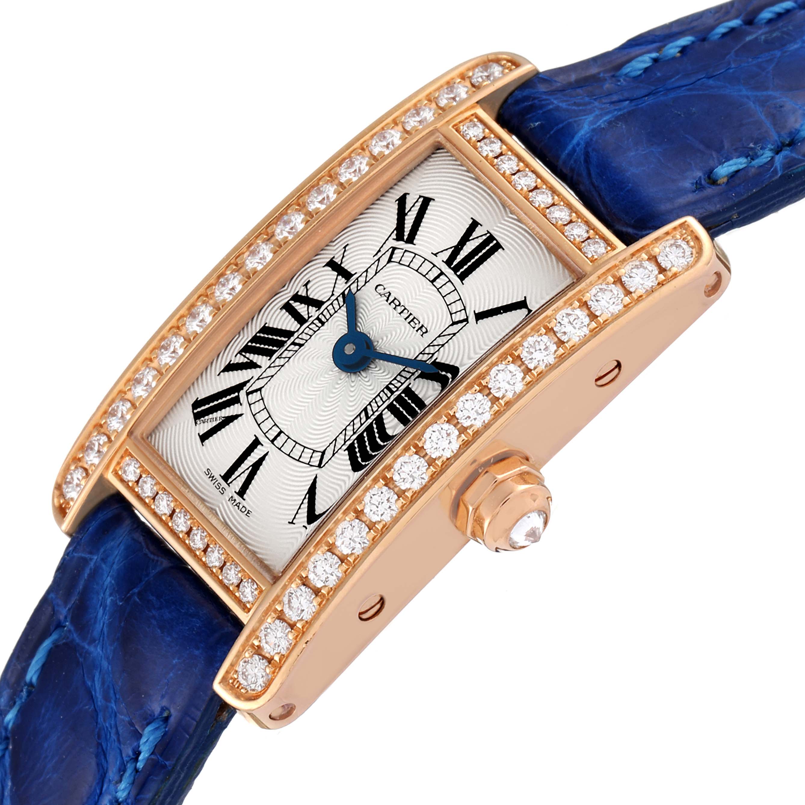 The image shows an angled view of the Cartier Tank Americaine WJTA0026 Women's Rose Gold Silver Dial WJTA0026 Women's Rose Gold Silver Dial watch, highlighting the face, blue strap, and diamond-studded bezel.