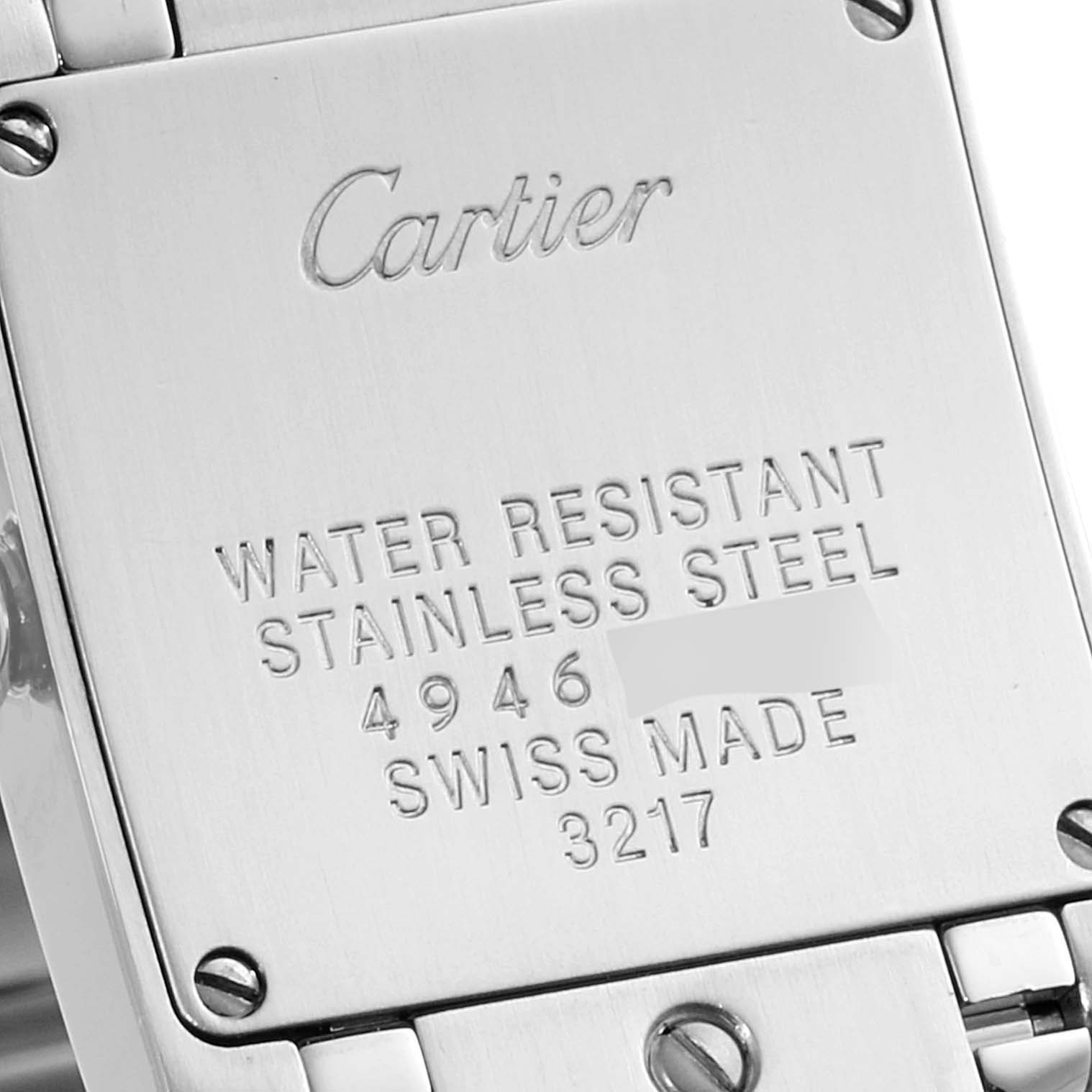 The image shows the back of a Cartier Tank Française watch, focusing on the engraved details and screws.
