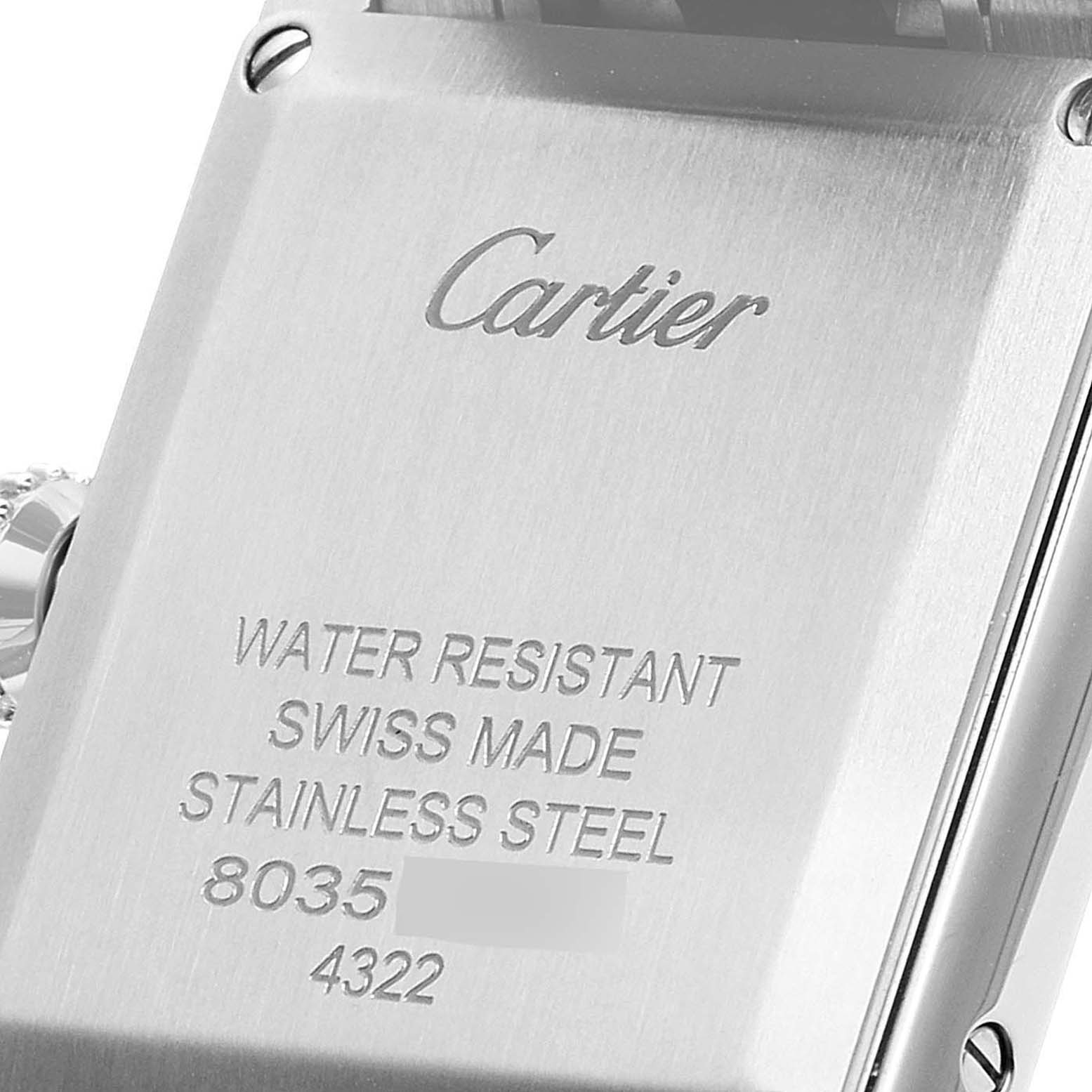 The image shows a close-up of the back case of a Cartier Tank Must WSTA0051 Women's Stainless Steel Silver Dial WSTA0051 Women's Stainless Steel Silver Dial watch, highlighting the branding and specifications.