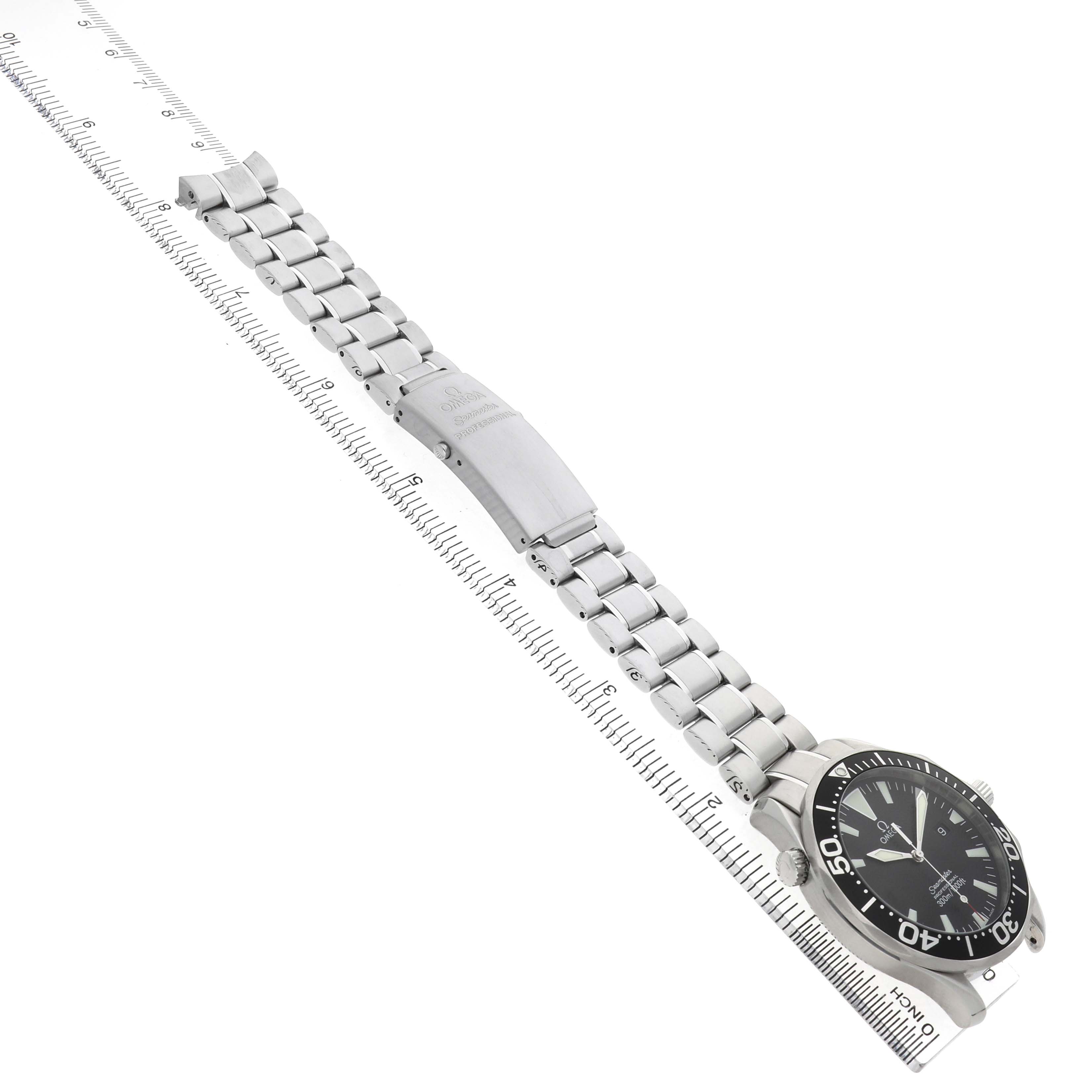 The Omega Seamaster 2264.50.00 Men's Stainless Steel Black Dial watch is shown from an angled side view, displaying its face, bracelet, and clasp alongside a ruler for scale.