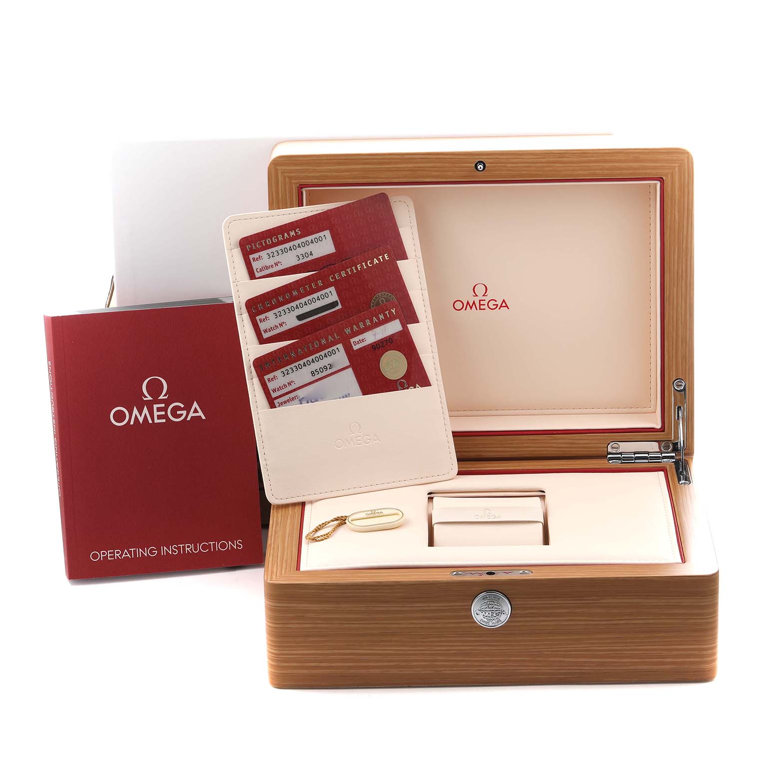 The image shows an Omega Speedmaster 323.30.40.40.04.001 Men
s Stainless Steel White Dial 323.30.40.40.04.001 Men
s Stainless Steel White Dial box, warranty cards, operating instructions, and a pouch, shot from a front angle.