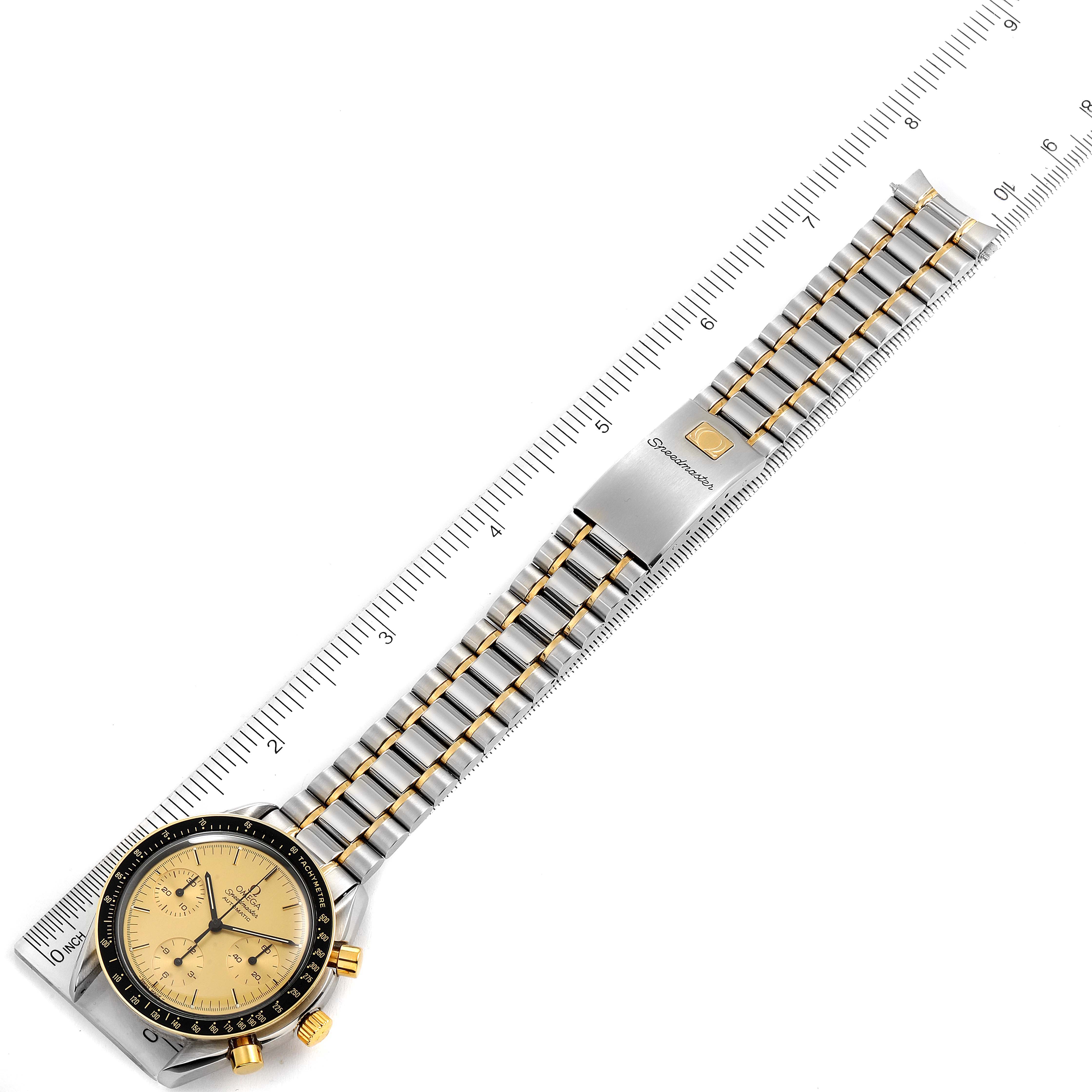 The image shows an overhead view of an Omega Speedmaster 3310.10.00 Men's Steel and Gold (two tone) Champagne Dial 3310.10.00 Men's Steel and Gold (two tone) Champagne Dial watch, displaying the face, bezel, bracelet, and clasp.