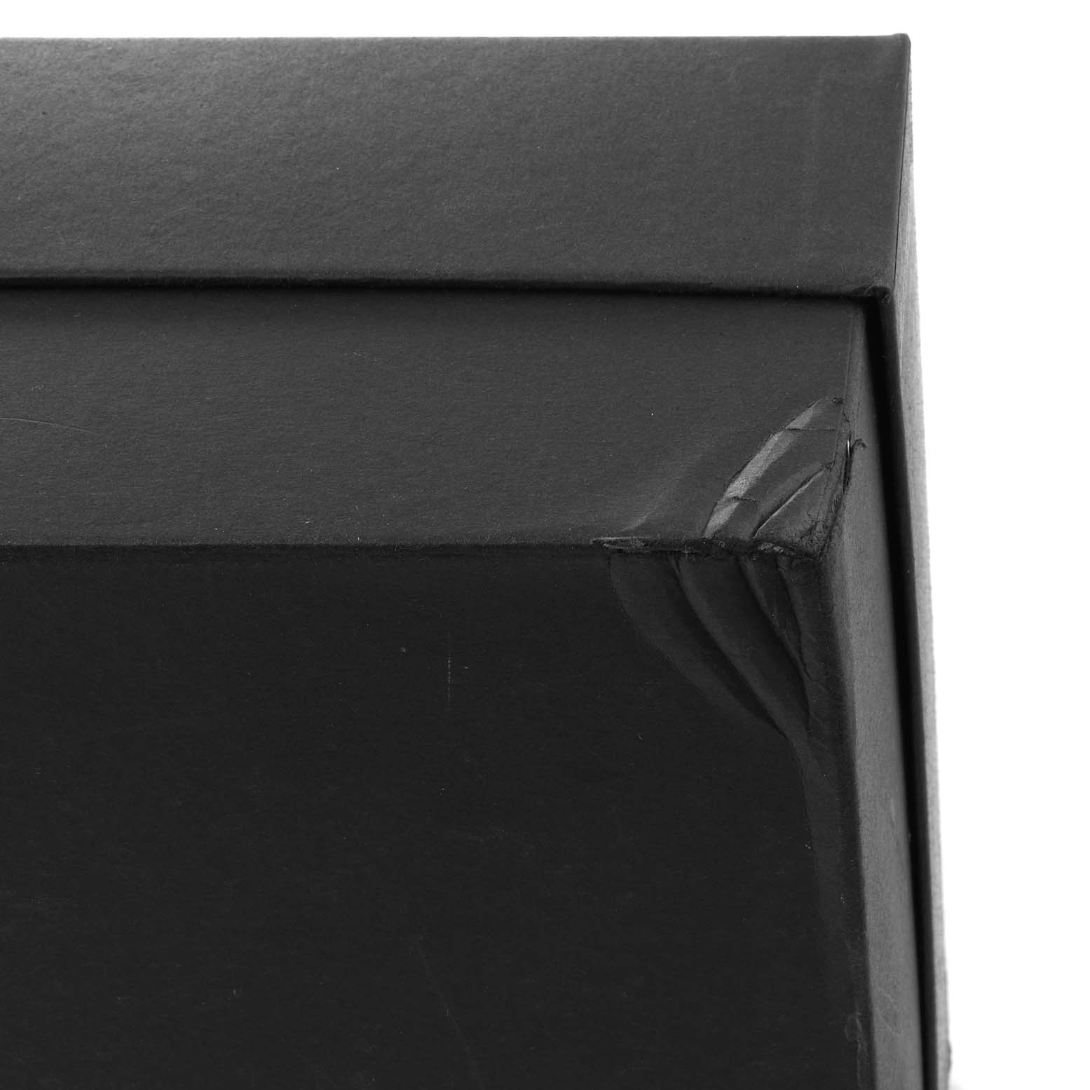 The image shows a close-up corner of the packaging box for the Panerai Luminor PAM00631 Men
s Stainless Steel Black Dial PAM00631 Men
s Stainless Steel Black Dial watch model.