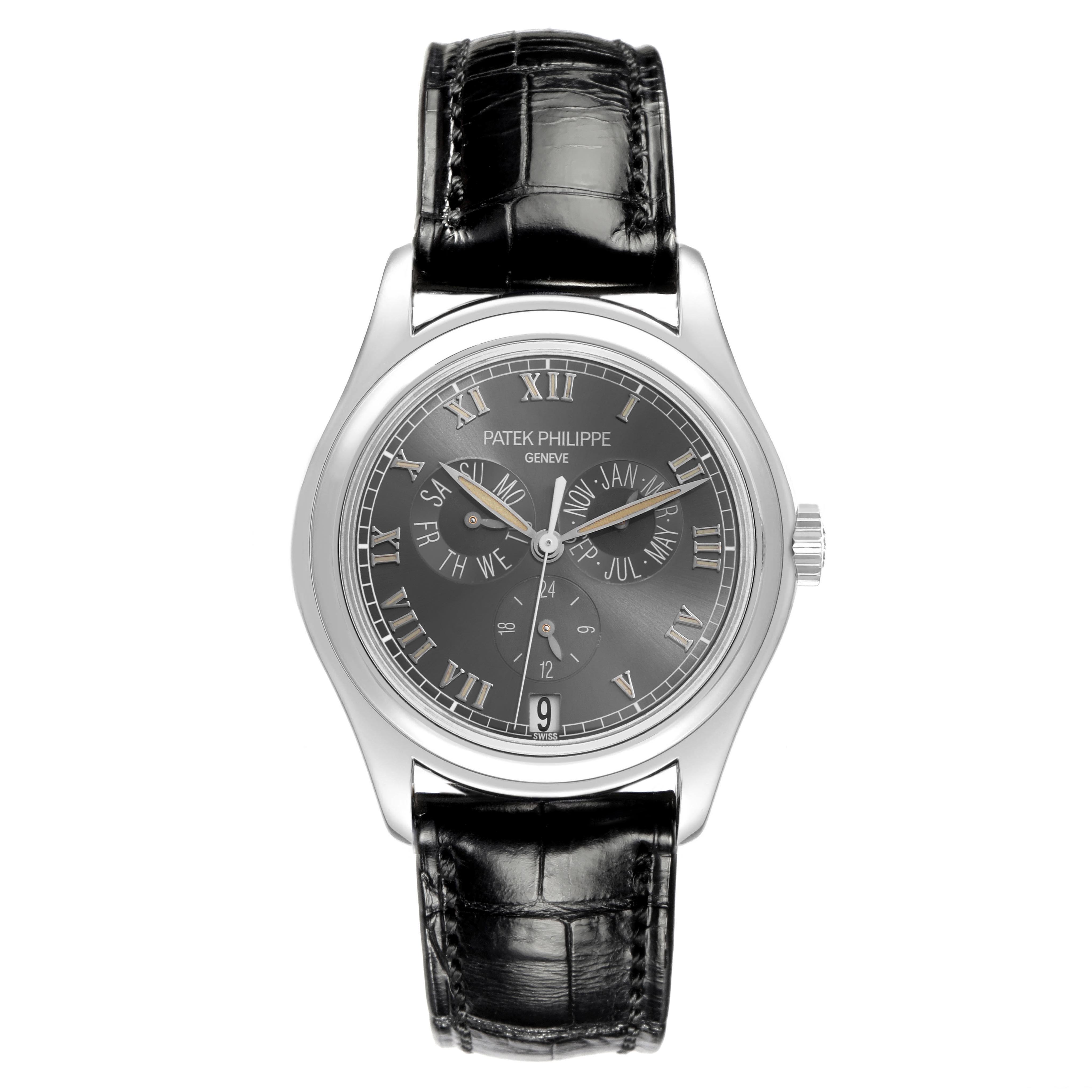 The Patek Philippe Complications 5035P-024 Men's Platinum Grey Dial 5035P-024 Men's Platinum Grey Dial watch is shown front-facing, highlighting its black dial, Roman numerals, and leather strap.