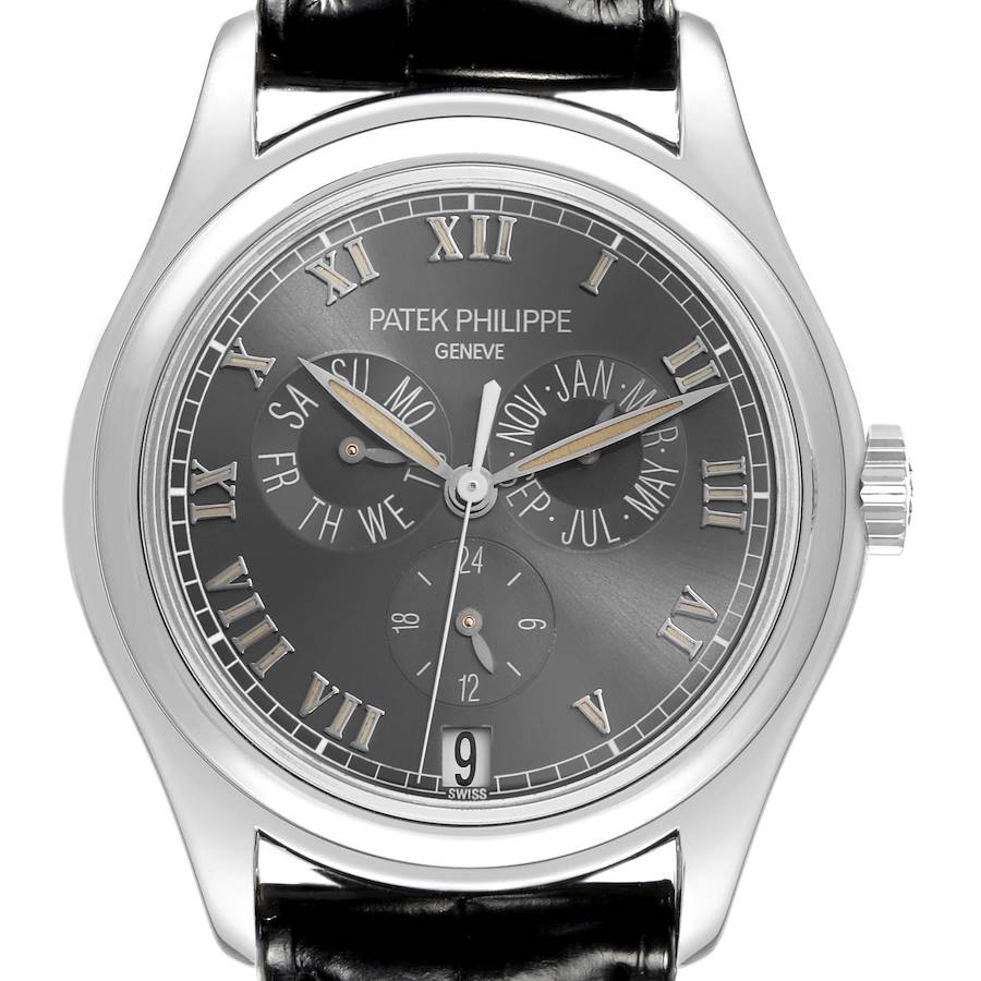 The Patek Philippe Complications watch is shown from a front angle, highlighting the dial, Roman numerals, subdials, and crown.