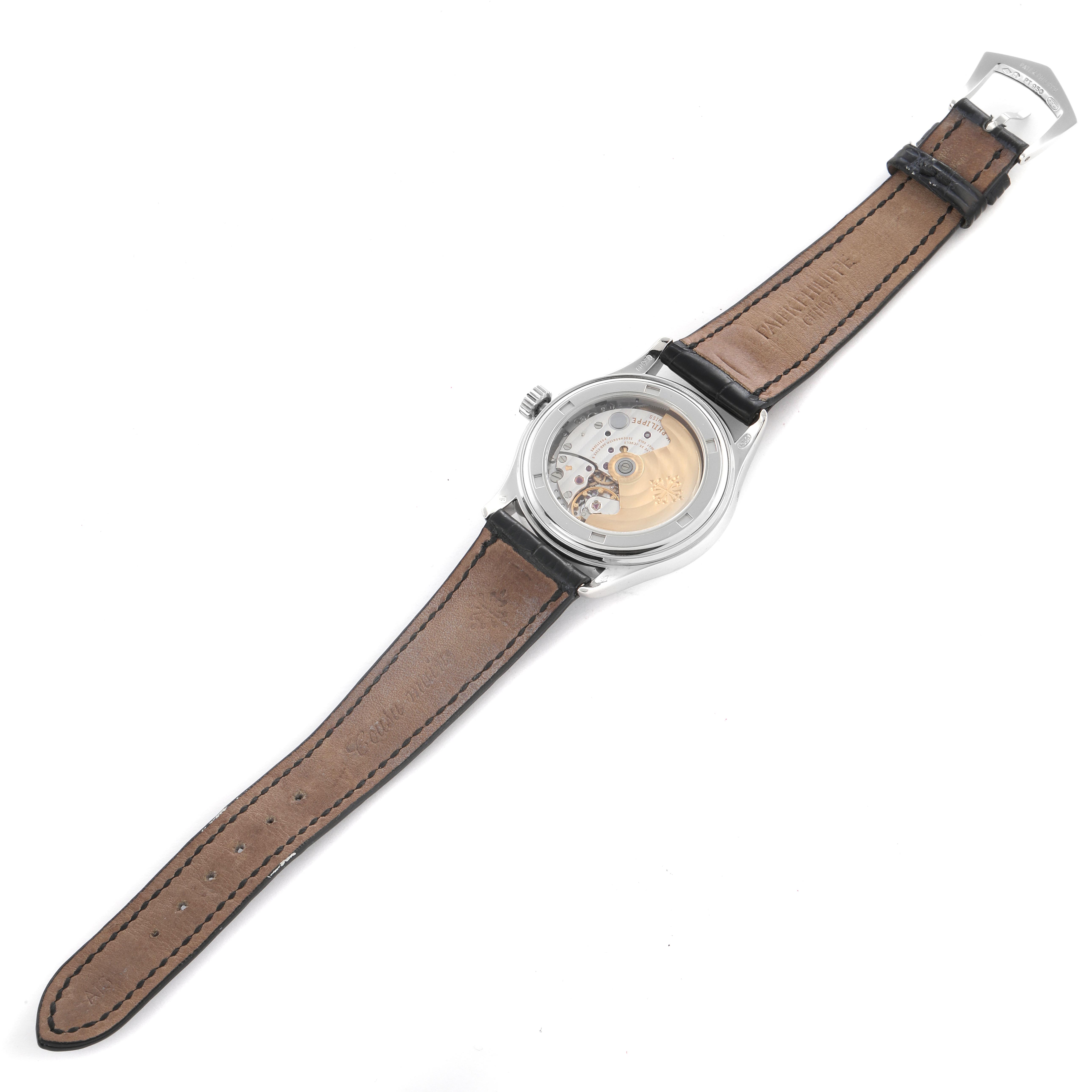 The Patek Philippe Complications 5035P-024 Men's Platinum Grey Dial 5035P-024 Men's Platinum Grey Dial watch is shown from the back, revealing its intricate movement and leather strap.