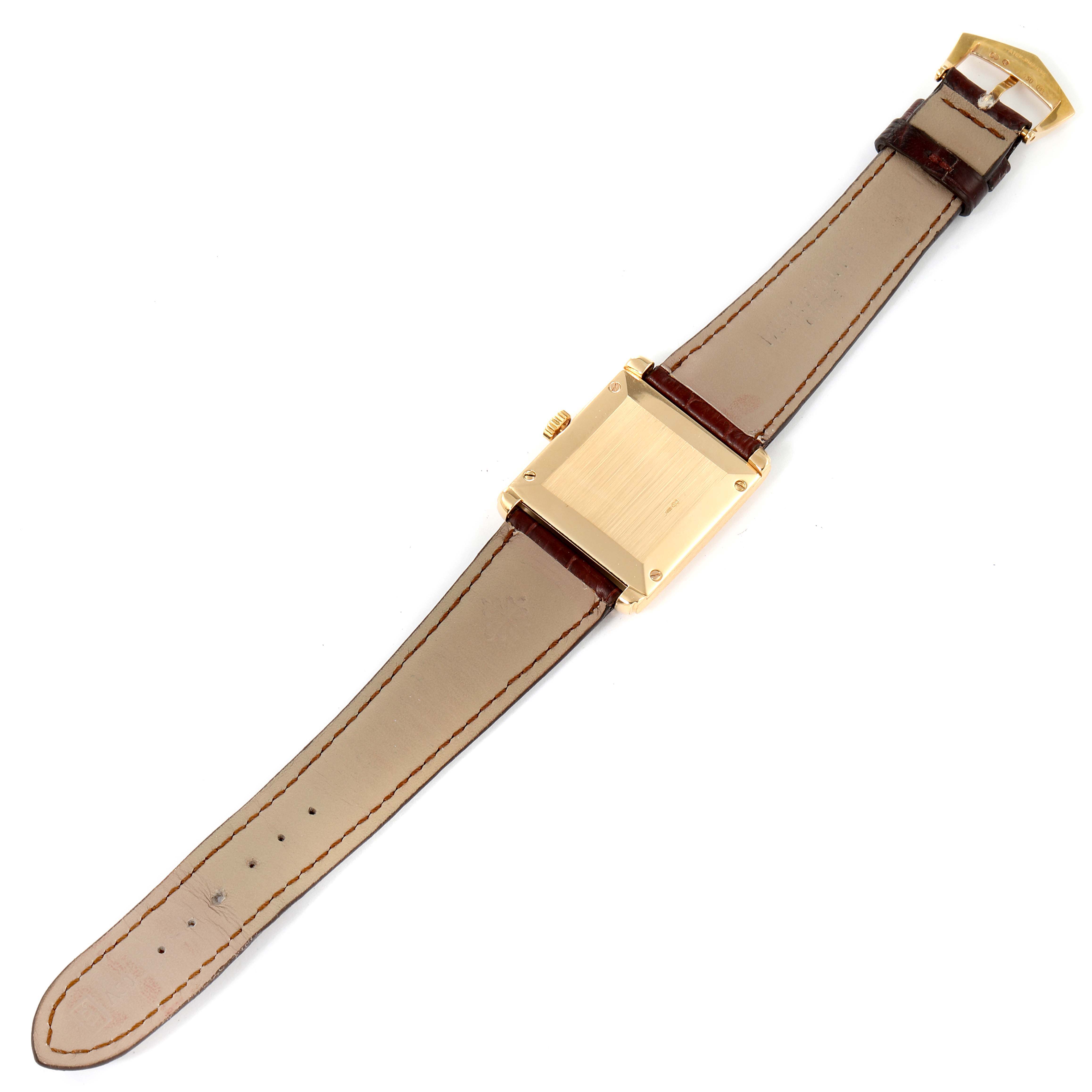 The image shows the back and strap of a Patek Philippe Gondolo 5014J Men's Yellow Gold White Dial 5014J Men's Yellow Gold White Dial watch from a top-down angle.