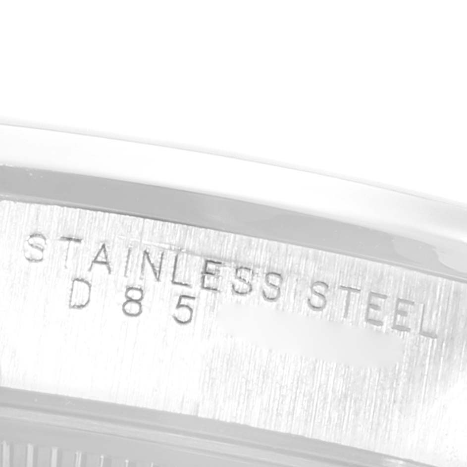 This close-up image shows the side of the stainless steel case of a Rolex Air-King 14000 Men's Stainless Steel Blue Dial 14000 Men's Stainless Steel Blue Dial watch, featuring engraved text.