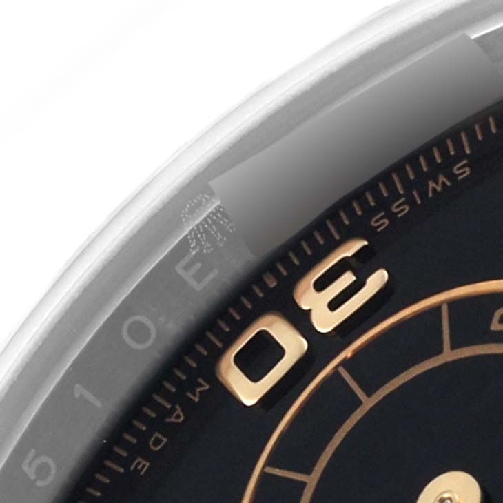 This image shows a close-up of the dial and part of the bezel of a Rolex Daytona 116503 Men
s Steel and Gold (two tone) Black Dial 116503 Men
s Steel and Gold (two tone) Black Dial watch.