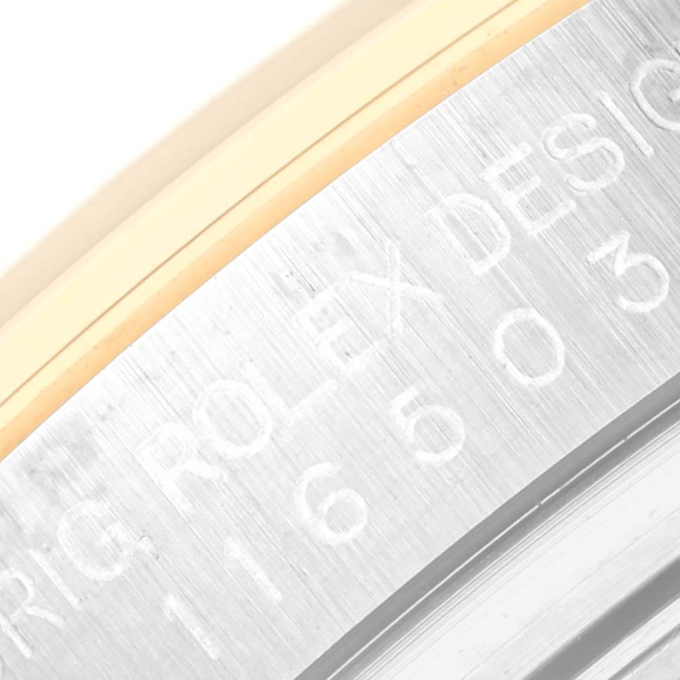 This image shows a close-up of the engraved side of the case of a Rolex Daytona 116503 Men
s Steel and Gold (two tone) Black Dial 116503 Men
s Steel and Gold (two tone) Black Dial watch.