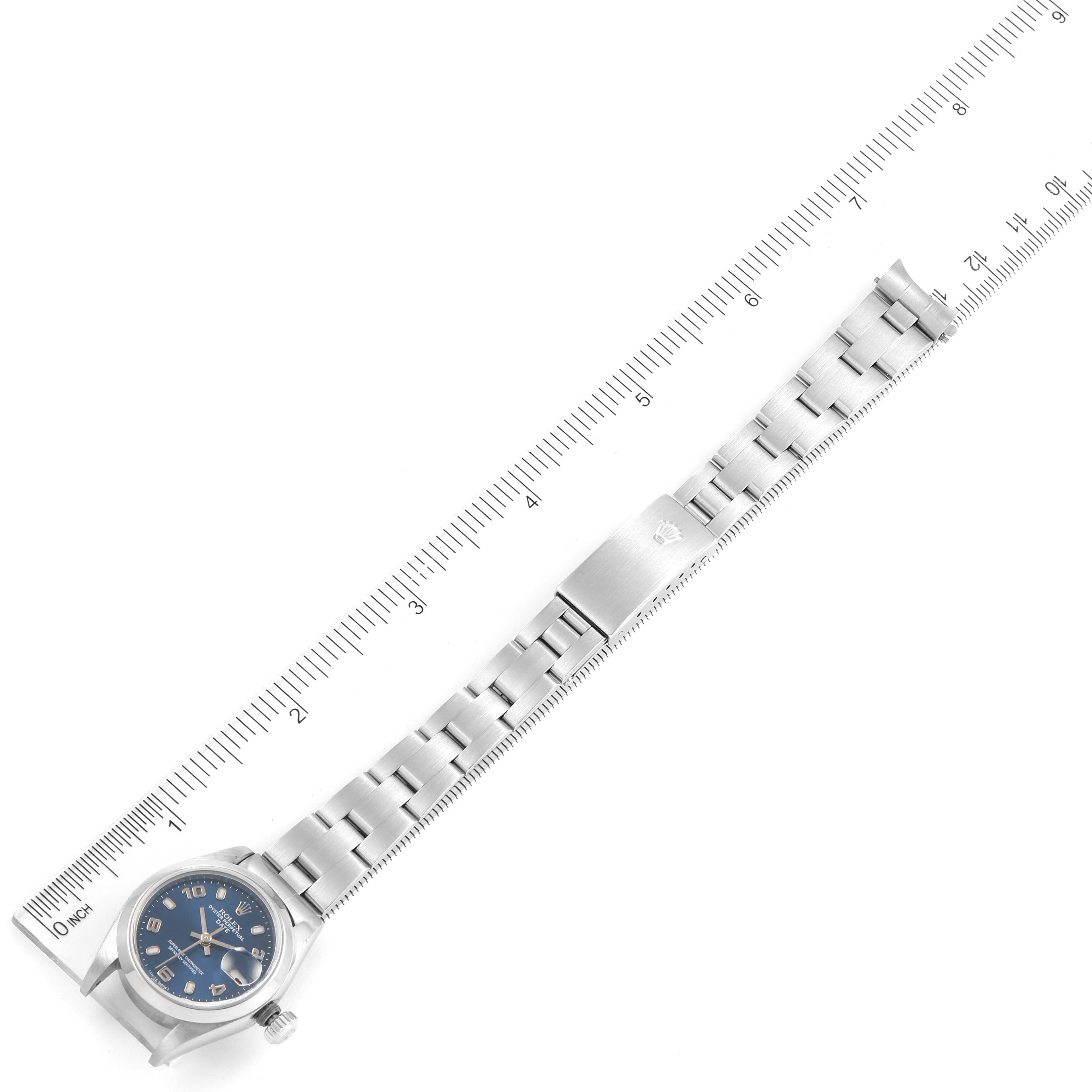 The image shows an overhead view of a Rolex Datejust 79160 Women's Stainless Steel Blue Dial 79160 Women's Stainless Steel Blue Dial watch with a blue dial and stainless steel bracelet, measured against a ruler.