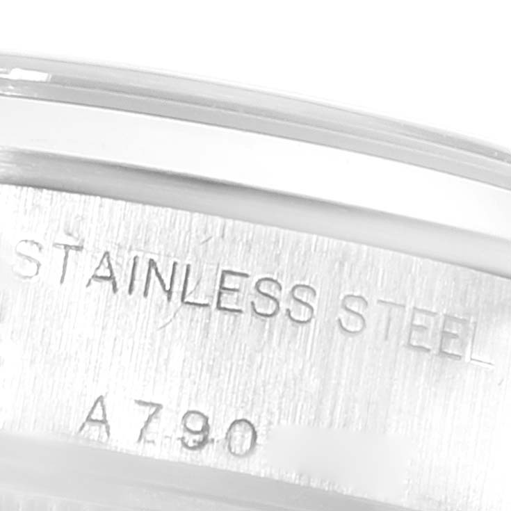 This image shows a close-up of the stainless steel case with engravings on a Rolex Datejust 79160 Women's Stainless Steel Blue Dial 79160 Women's Stainless Steel Blue Dial watch.