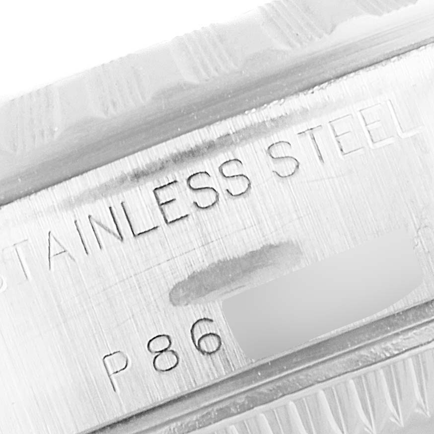 This image shows a close-up of the engraving on a Rolex Date 79240 Women
s Stainless Steel Blue Dial 79240 Women
s Stainless Steel Blue Dial model watch, highlighting the stainless steel material and part of the serial number.