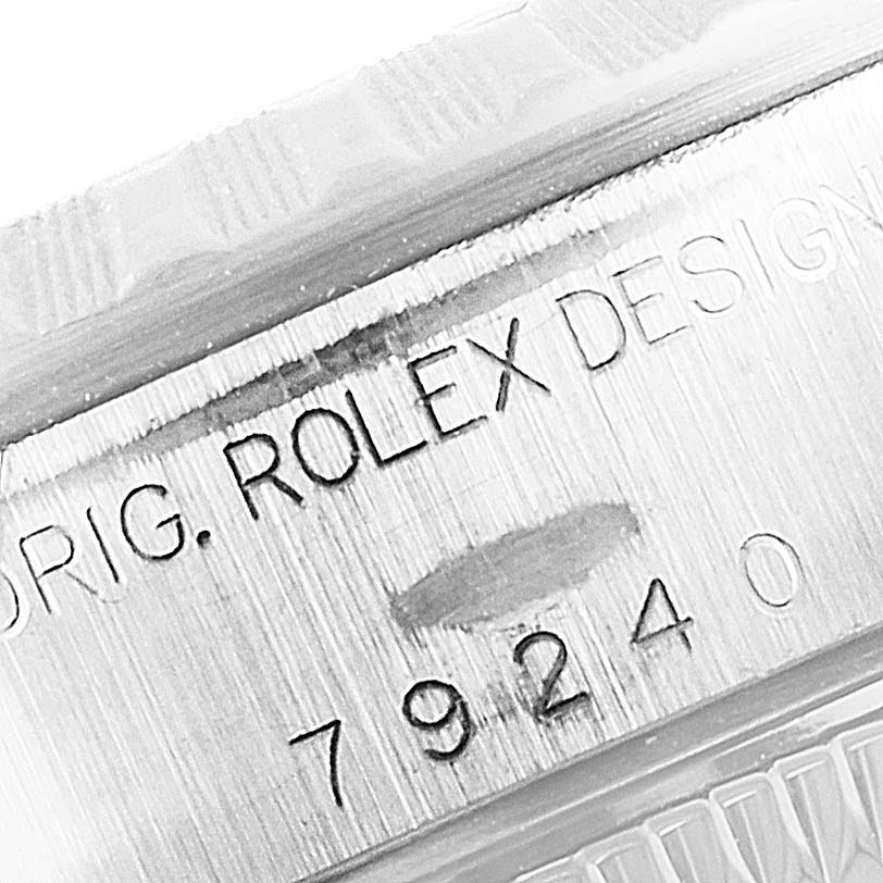 The image shows a close-up of the engraved serial number and part of the bezel on the Rolex Date 79240 Women
s Stainless Steel Blue Dial 79240 Women
s Stainless Steel Blue Dial watch.
