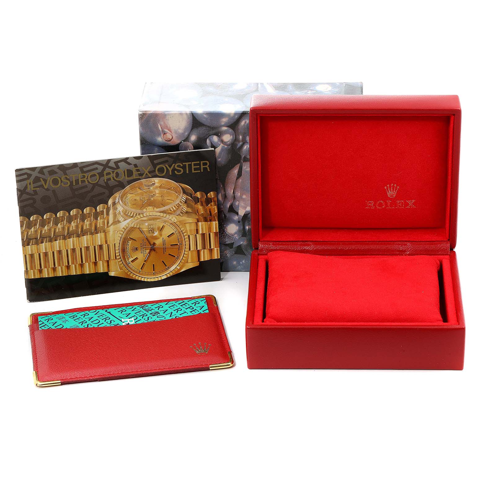 This image shows the accessories for a Rolex Date 79240 Women
s Stainless Steel Blue Dial 79240 Women
s Stainless Steel Blue Dial model, including a red watch box, a booklet, and a leather cardholder.