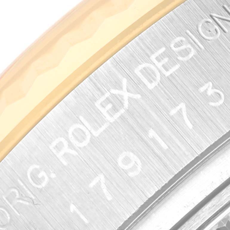 The image shows a close-up of the side engraving on the bezel of a Rolex Datejust 179173 Women's Steel and Gold (two tone) Silver Dial 179173 Women's Steel and Gold (two tone) Silver Dial watch.