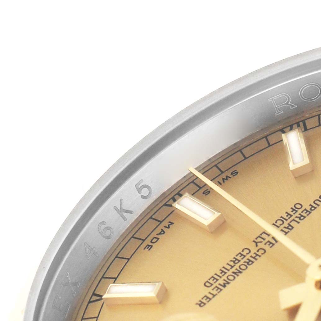 The image shows a close-up of the Rolex Datejust 116233 Men's Steel and Gold (two tone) Champagne Dial dial, bezel, and part of the watch hands.