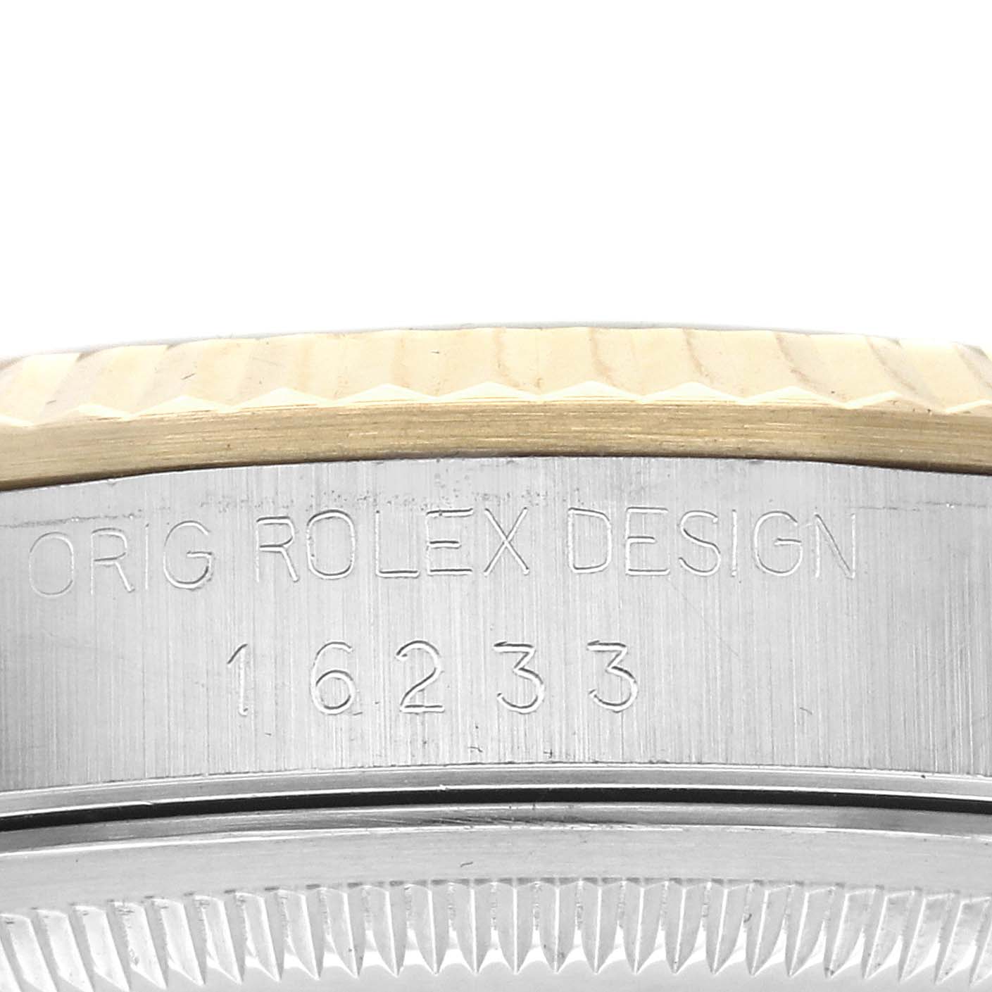 The image shows a side view of a Rolex Datejust 16233 Men
s Steel and Gold (two tone) Champagne Dial 16233 Men
s Steel and Gold (two tone) Champagne Dial watch, highlighting the engraved model number and bezel design.