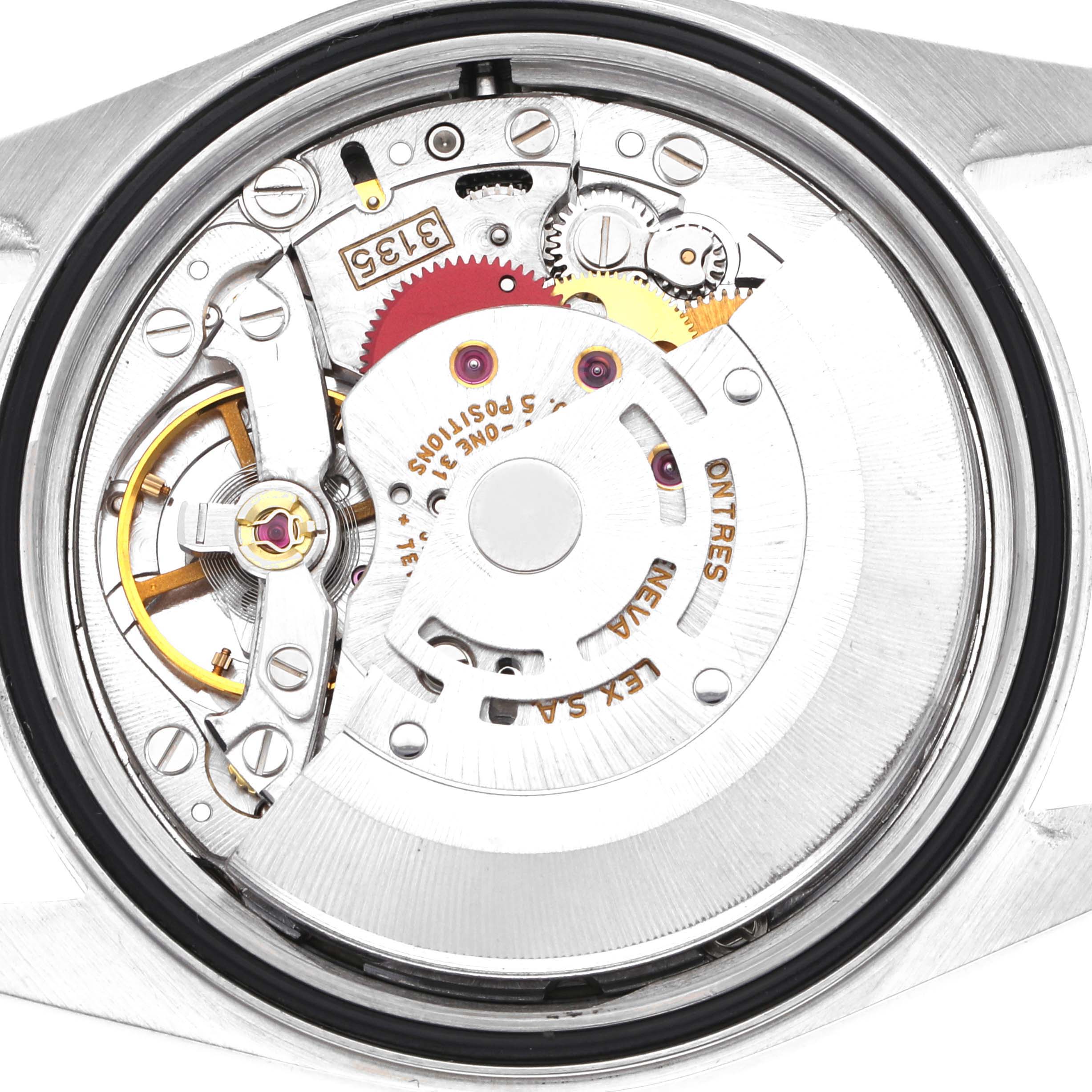 The image shows the movement of a Rolex Datejust 16233 Men
s Steel and Gold (two tone) Champagne Dial 16233 Men
s Steel and Gold (two tone) Champagne Dial watch from the back, highlighting gears and the rotor.