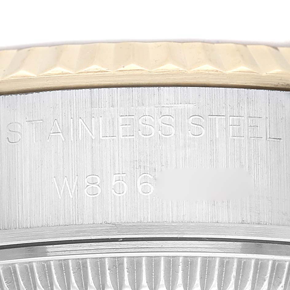 This image shows a close-up of the side engraving and the fluted bezel of a Rolex Datejust 69173 Women
s Steel and Gold (two tone) Champagne Dial 69173 Women
s Steel and Gold (two tone) Champagne Dial watch.