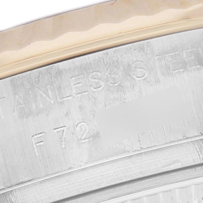 The image shows a close-up of the side of a Rolex Datejust 179173 Women's Steel and Gold (two tone) Champagne Dial 179173 Women's Steel and Gold (two tone) Champagne Dial, focusing on the engraved lettering on the case.