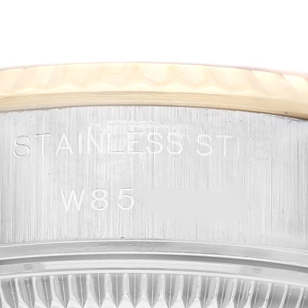 This image shows a close-up of the engraved side of a Rolex Datejust 69173 Women's Steel and Gold (two tone) Champagne Dial 69173 Women's Steel and Gold (two tone) Champagne Dial watch, highlighting the serial number and stainless steel text.