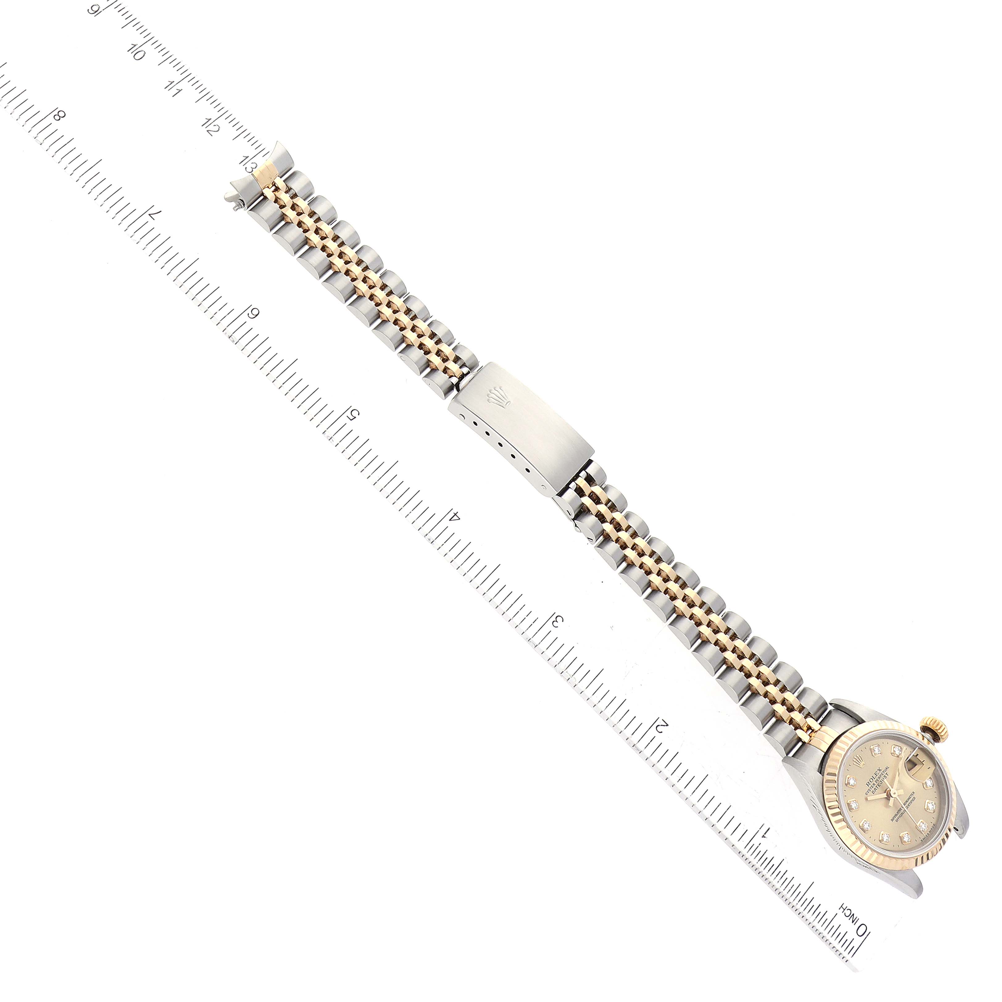 The image shows the full length of a Rolex Datejust 69173 Women's Steel and Gold (two tone) Champagne Dial 69173 Women's Steel and Gold (two tone) Champagne Dial watch, including its face and two-tone bracelet, laid alongside a ruler.
